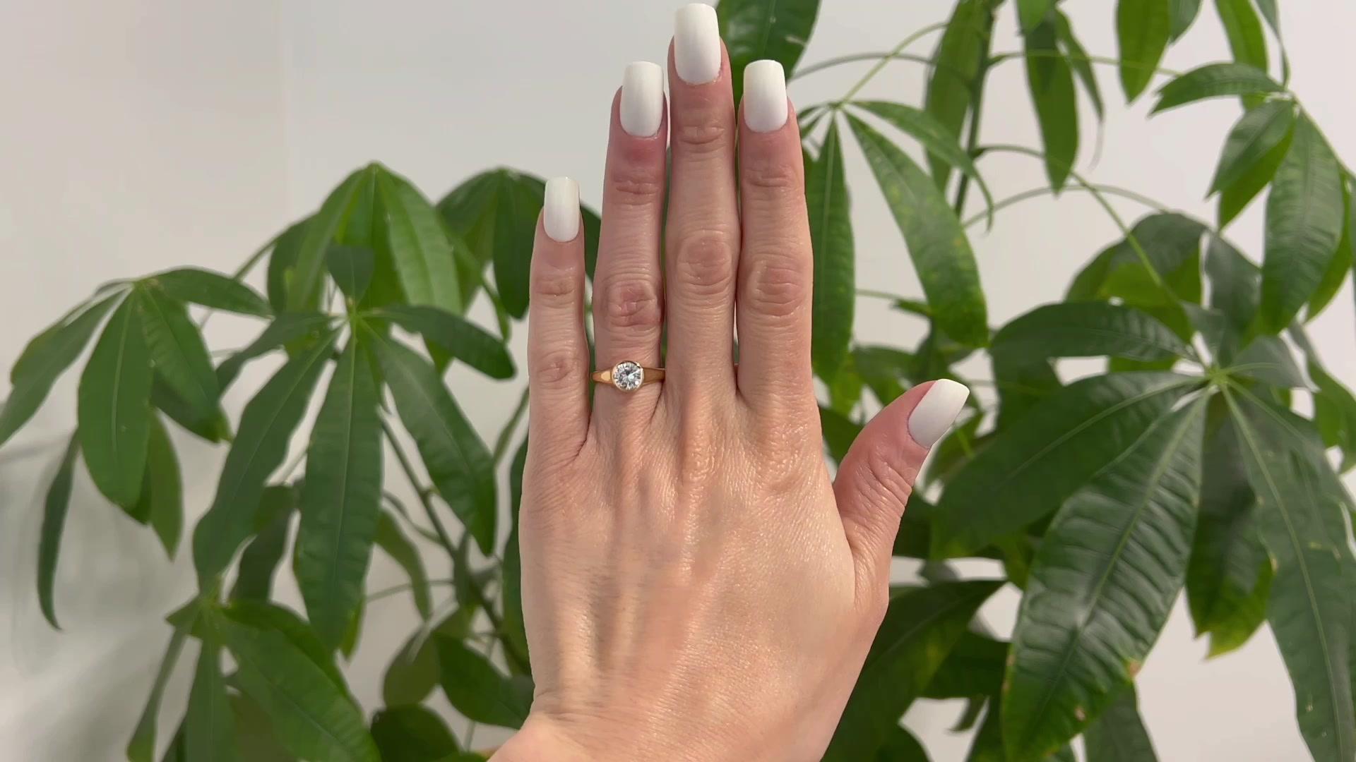 One Vintage Bvlgari GIA 1.00 Carat Round Brilliant Cut Diamond 18k Yellow Gold Solitaire Ring. Featuring one GIA round brilliant cut diamond of 1.00 carat, accompanied with GIA #2136499 stating the diamond is E color, VS1 clarity. Crafted in 18