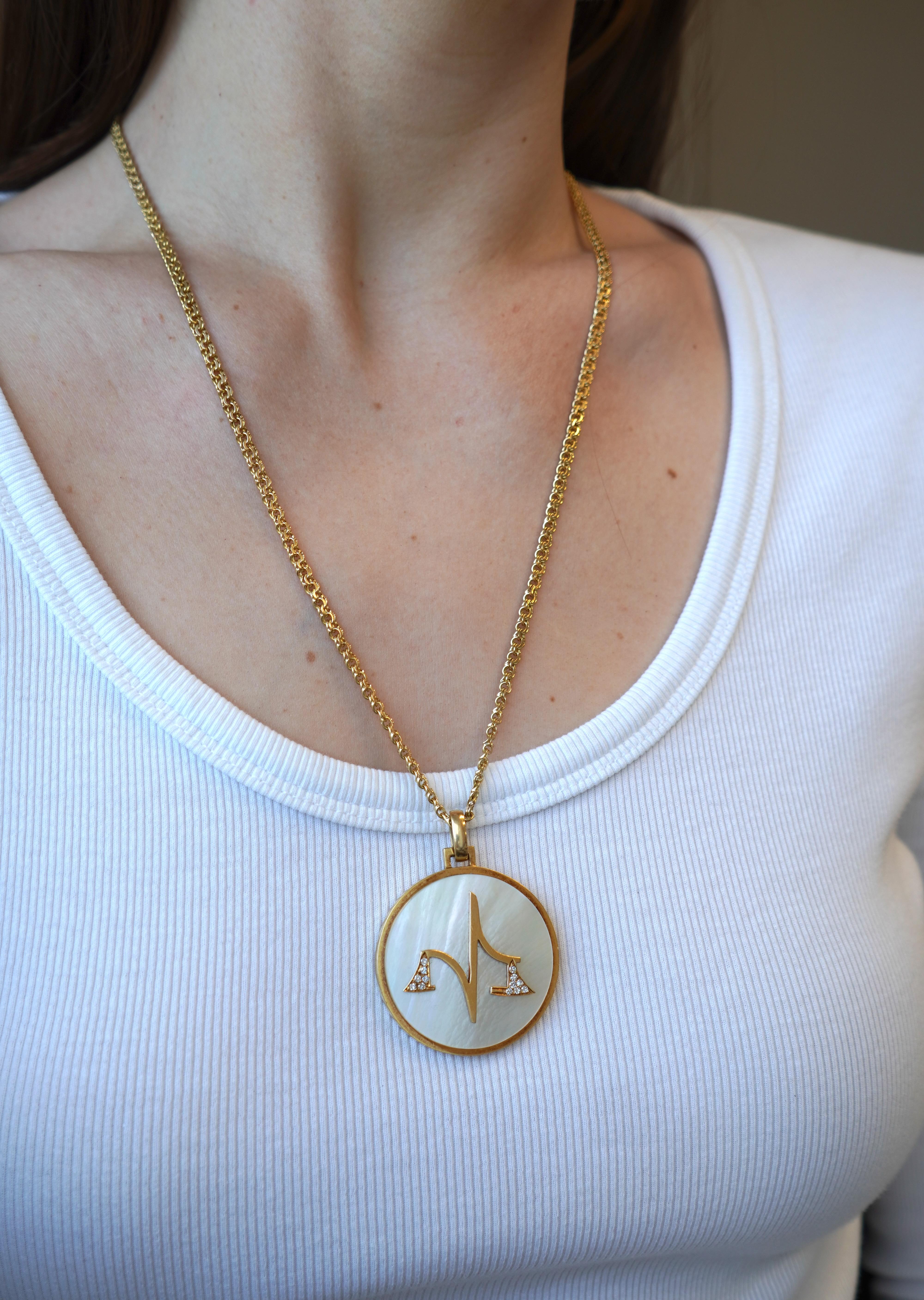 Crafted in the 1970s, the Vintage Bvlgari Libra Zodiac pendant embodies celestial elegance. Fashioned from lustrous 18k gold and adorned with exquisite mother of pearl, this pendant is a testament to impeccable craftsmanship. Contains the markings: