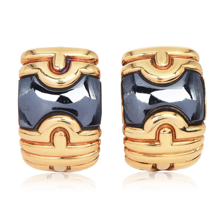 These vintage Blgari pieces from the Parentesi collection, showcase highly polished hematite plaques.

A retro design clip-on earrings, made of solid 18K Yellow gold with a bright polished finish.

They measure approximately 22 mm x 13 mm, are