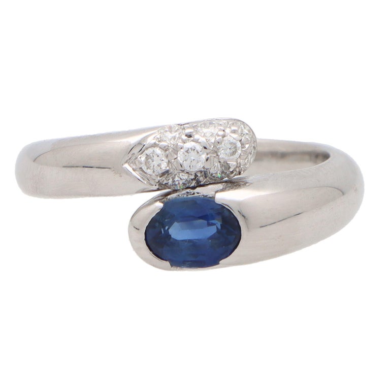 An iconic vintage Bvlgari Serpenti Bypass ring set in 18k white gold. 

The ring depicts Bvlgari's well-known serpent motif which wraps round the finger elegantly. The head is solely set with an oval cut vibrant blue sapphire which is securely bezel