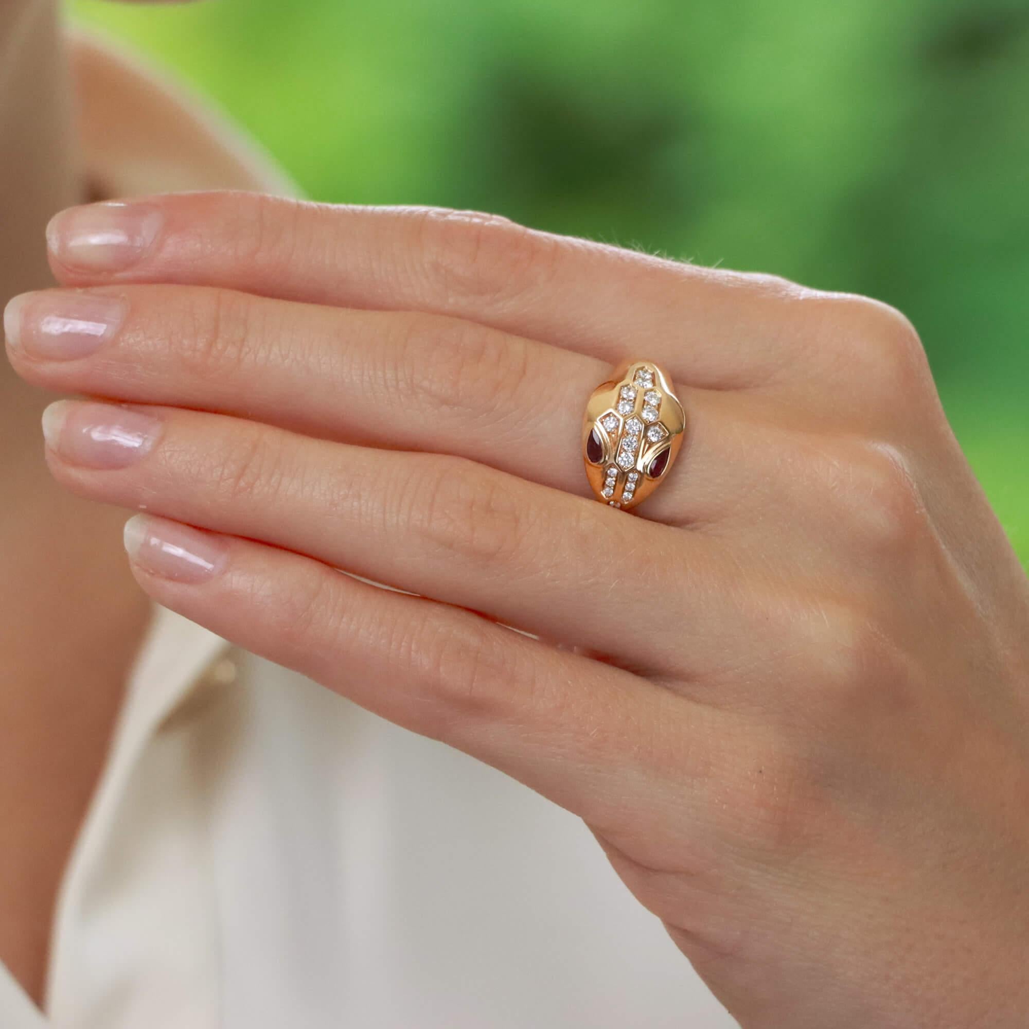  An iconic vintage Bvlgari Serpenti ring set in 18k rose gold.

The ring depicts Bvlgari's well-known serpent motif which wraps round the finger elegantly. It is comprised of a snakes head, set with 18 round brilliant cut diamonds with two