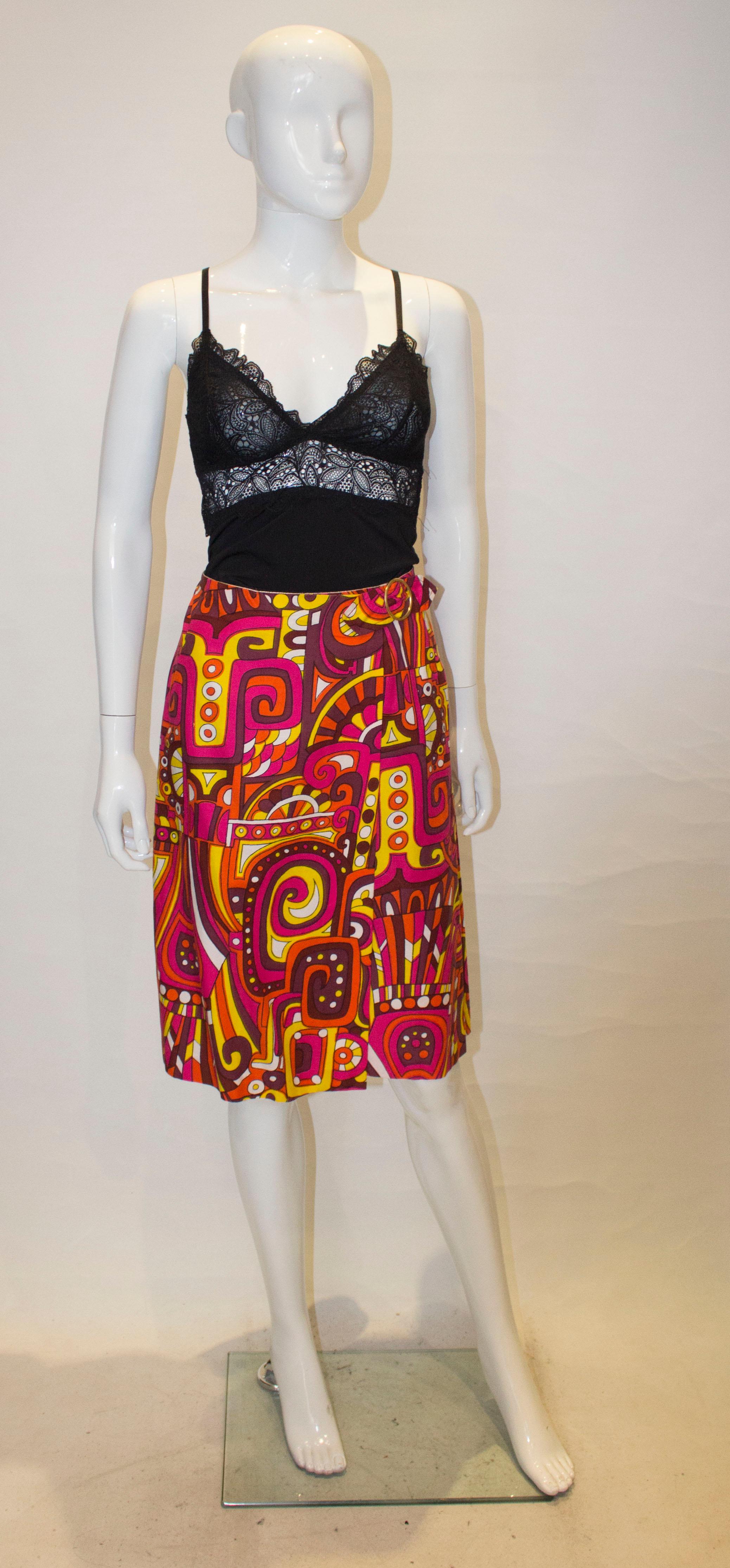 A fun vintage skirt by ' By Laddies' . In a cotton print , the skirt is a mix of pink, yellow, purple and  and white. 