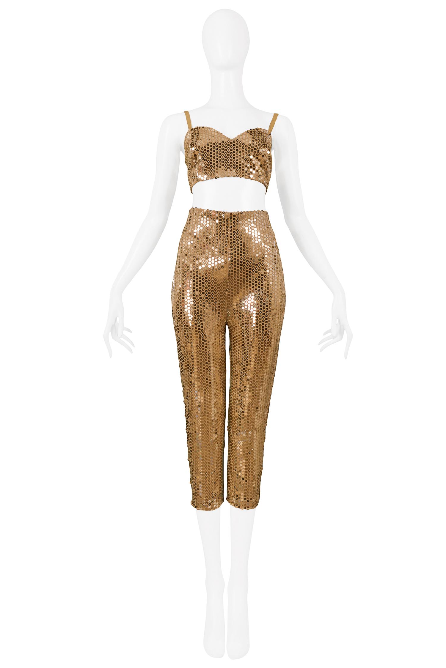 Vintage Byblos gold sequin bra top and cigarette pant ensemble. Bra top features 3-button closure at back, and pants are high waisted with center back zipper closure. Collection 1991.

Excellent Vintage Condition.

Size:
Top 44
Pants 42