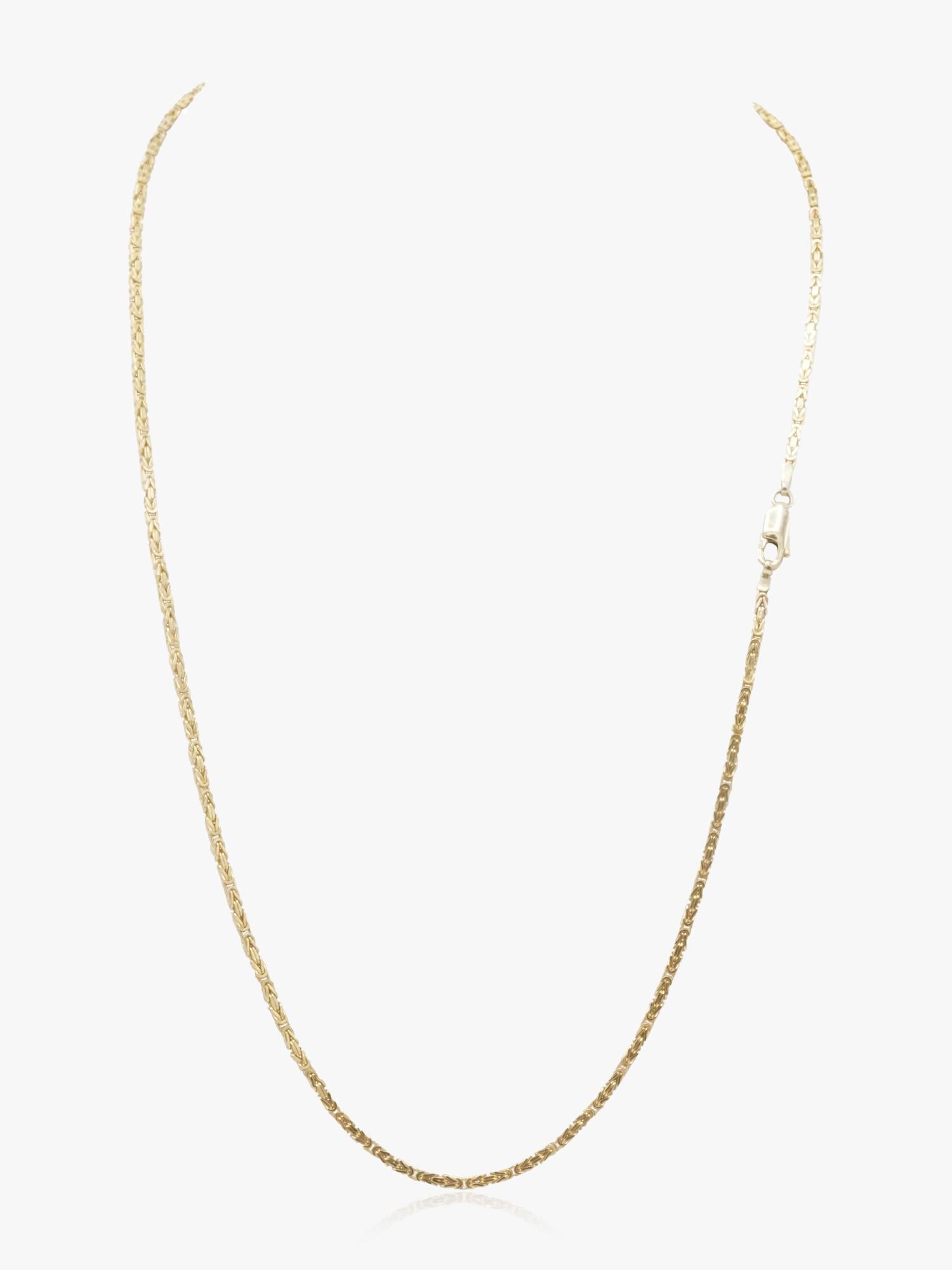 Vintage Byzantine style chain in 14k gold weighing 13.5 grams and measuring 22 inches. With a rare square profile, this solid chain has a textured pattern achieved through meticulous interlocking links, providing a unique twist on the classic