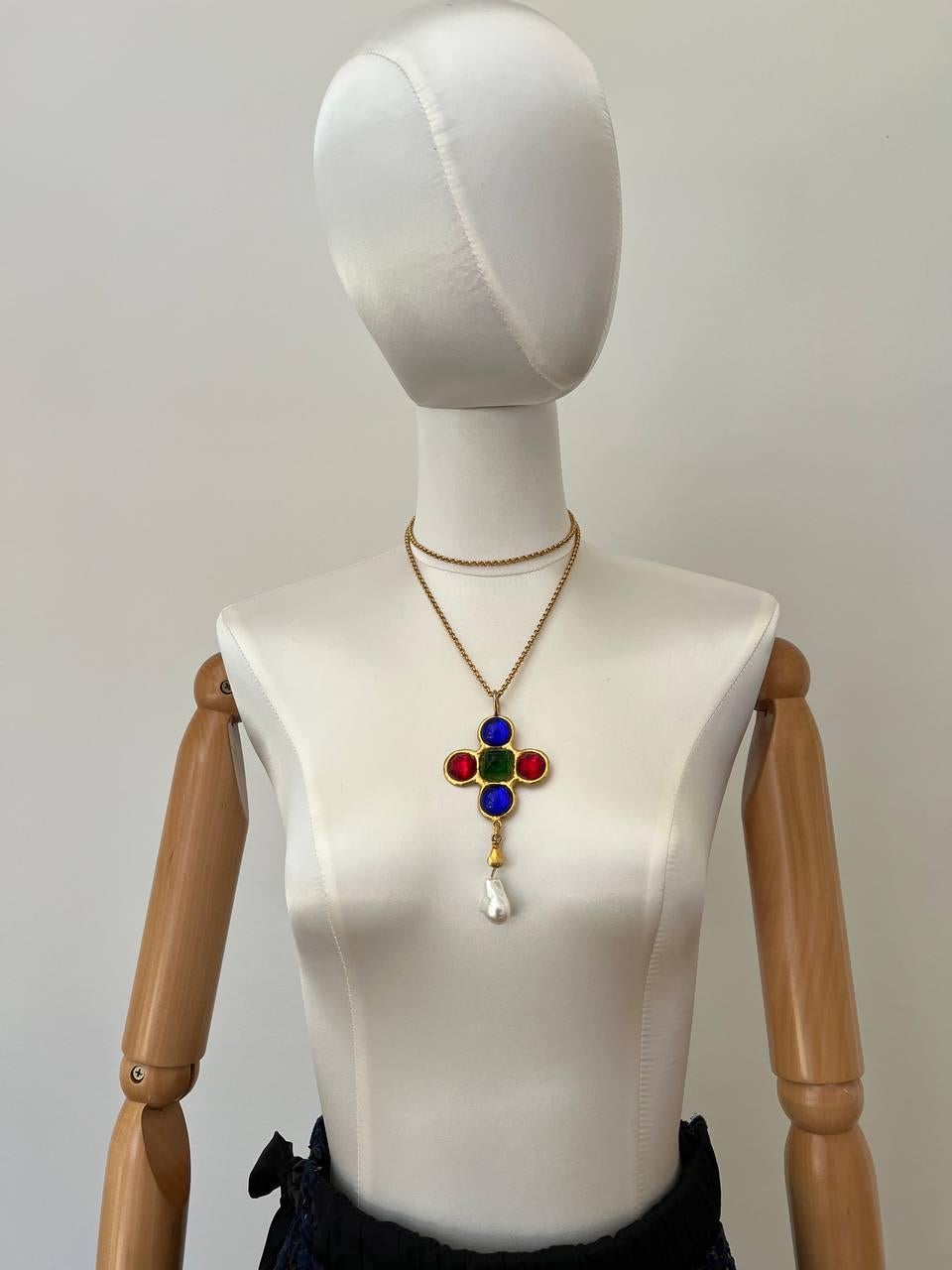 Vintage Byzantine style Yves Saint Laurent pendant featuring cross and dangling Baroque pearl. Decorated with blue, red, green cabochons. 
Signed. Yves Saint Laurent.Rive Gauche. Made in France
Period: 1980s
Pendant length: 11cm
Chain length: 50 cm