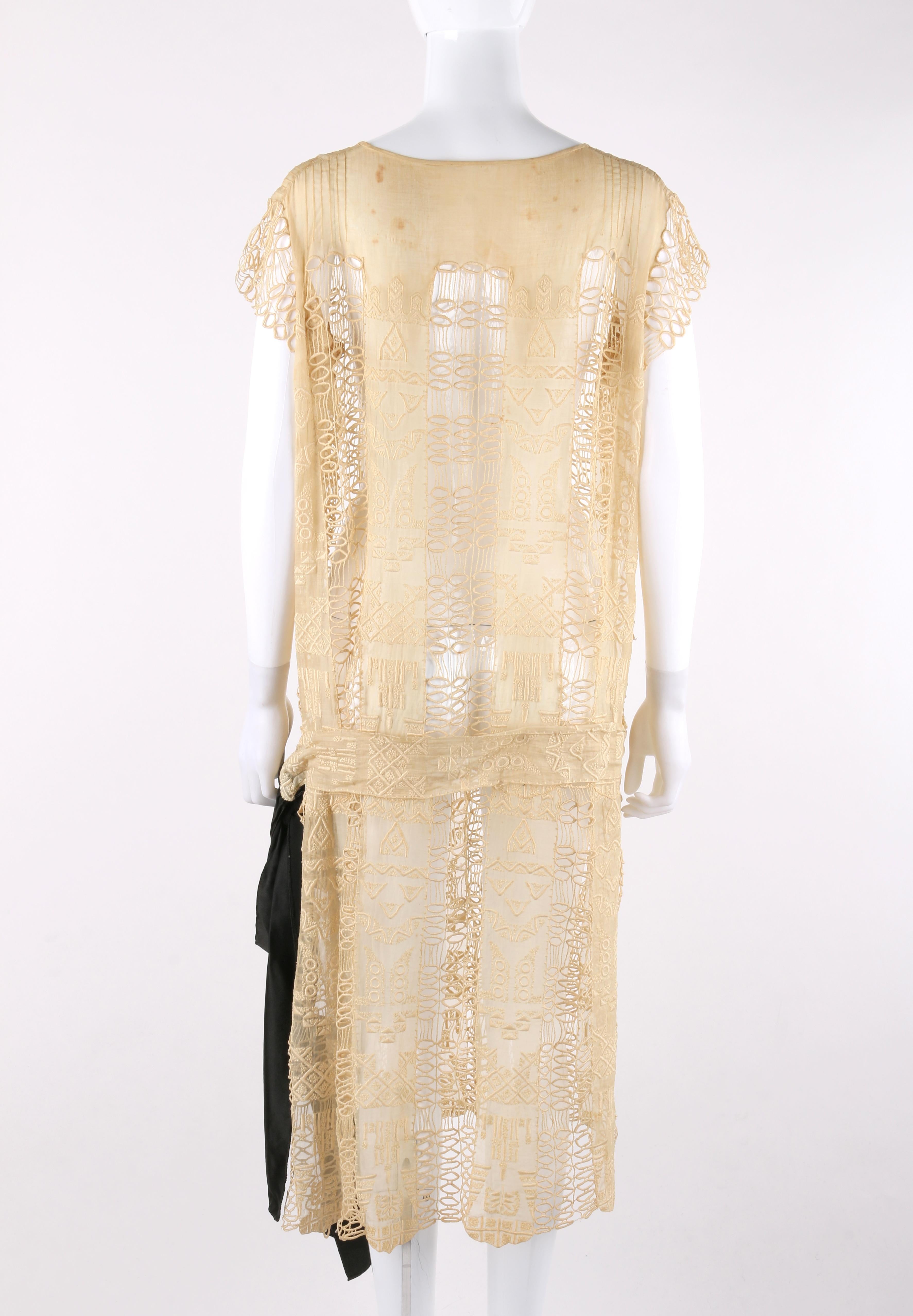 VINTAGE c.1920’s Drop Waist Belted Black Bow Ivory Lace Sheer Cotton Shift Dress

Circa: 1920’s 
Label(s): None
Style: Drop waist shift dress
Color(s): Shades of ivory and black
Lined: No 
Unmarked Fabric Content (feel of): Cotton
Additional Details
