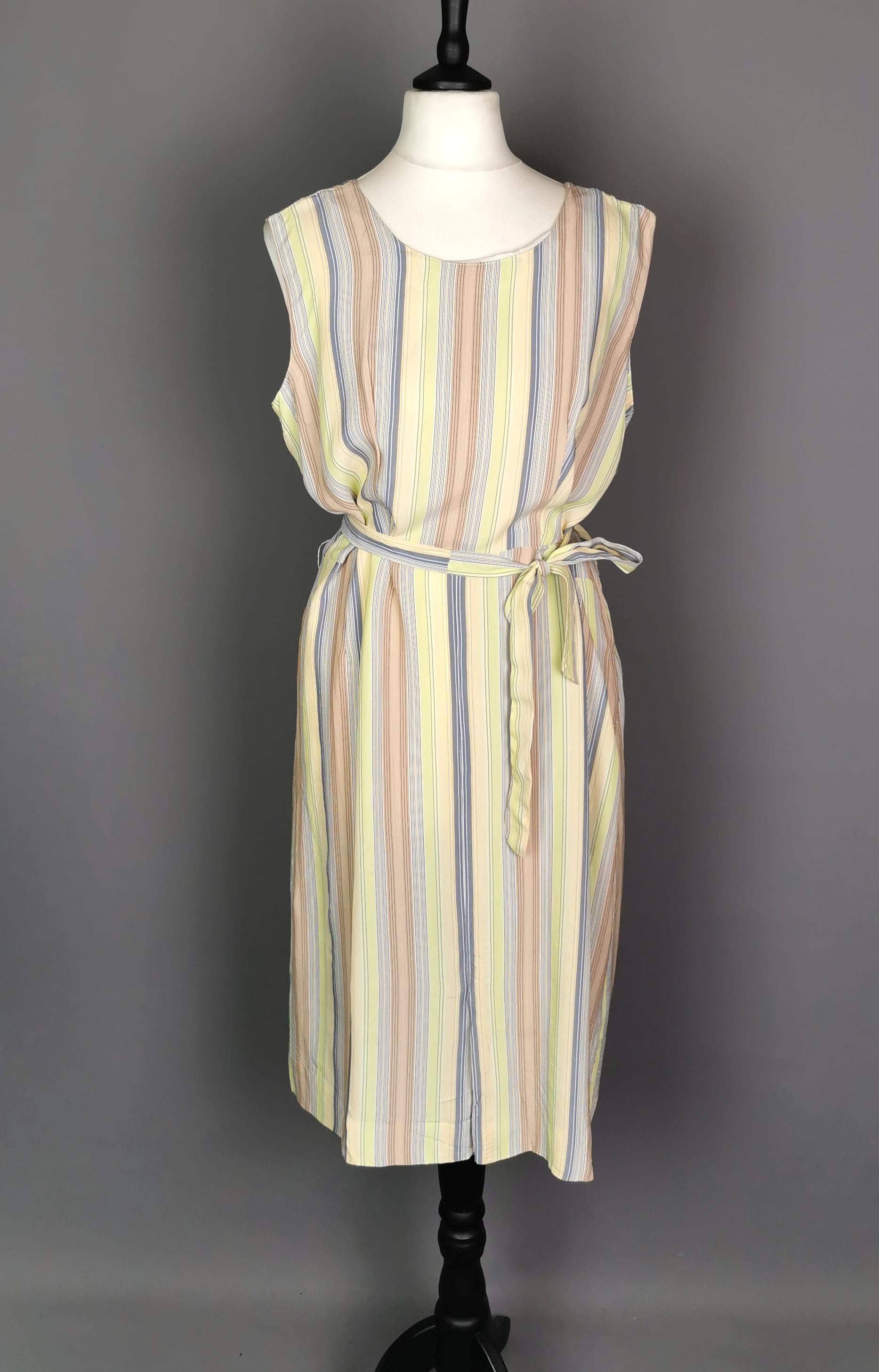 A sweet vintage c1930s striped day dress.

A lovely lightweight piece, late 1930's made from silky rayon with a stripe print.

The stripes are in greens, blues and browns on a light ground.

The dress is sleeveless with a round neckline and a