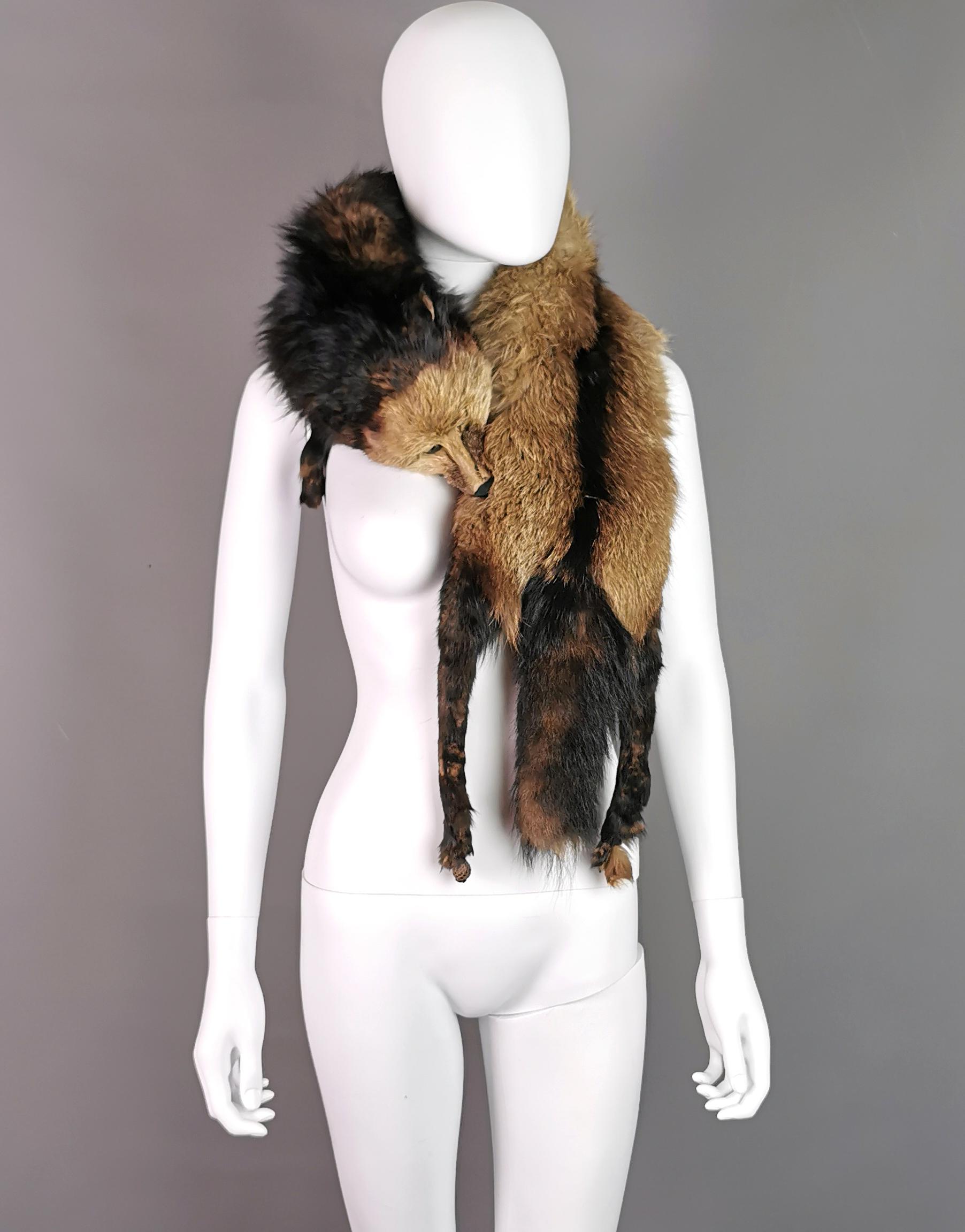 A beautiful vintage c1940s real fur stole or tippet.

It is a large and luxurious stole, made from high quality real marten fur with the head, tail and feet intact, one foot is missing, the stole has glass eyes and a celluloid clip under the head to