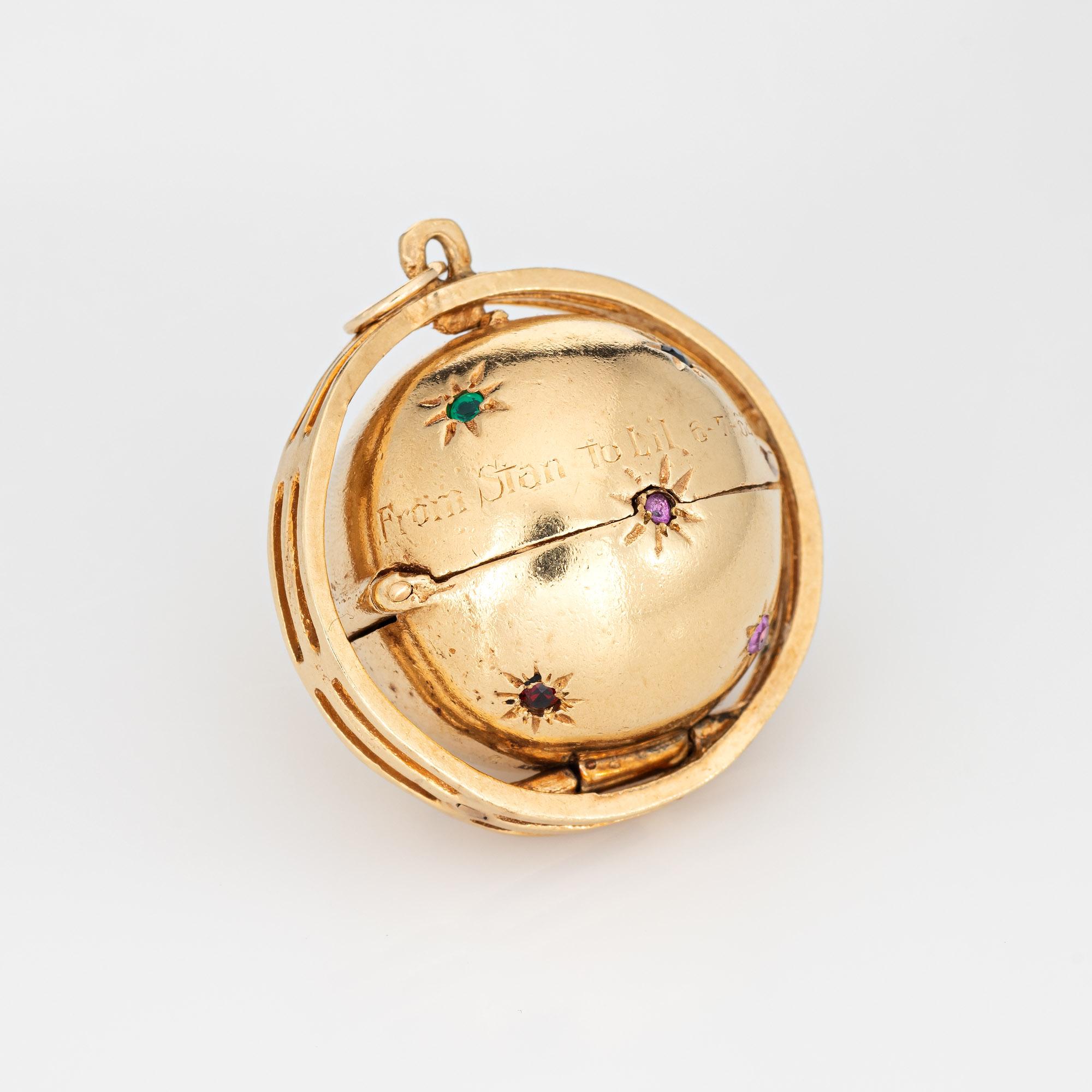 Finely detailed vintage folding picture charm (circa 1962) crafted in 14 karat yellow gold. 

The orb is secured with a hinged clip to allow the picture frames to collapse and contract neatly back into the orb. A total of three picture frames are