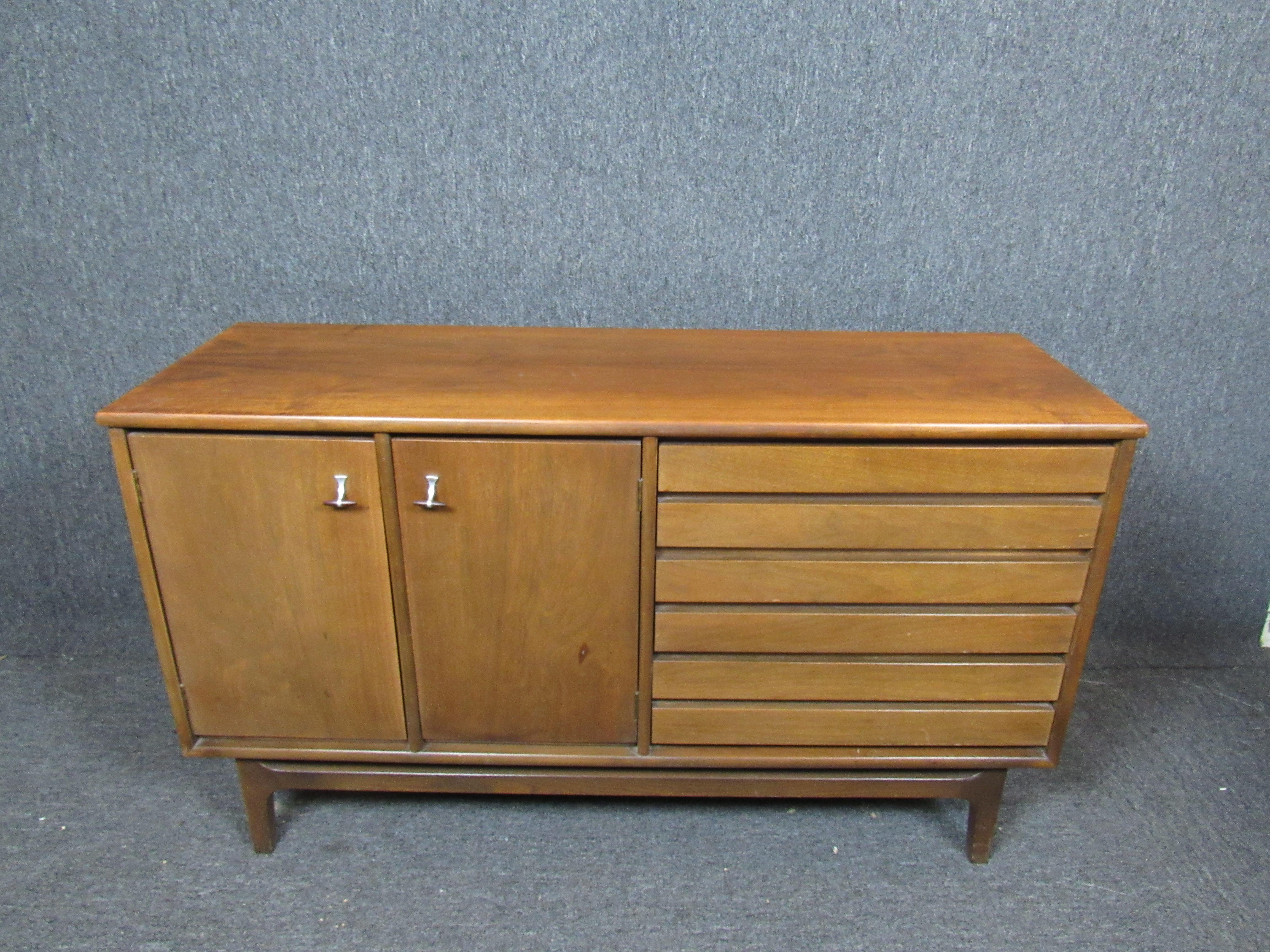 This vintage cabinet by Stanley features two large doors that open to reveal spacious storage compartments, and three drawers. Please confirm item location with seller (NY/NJ).