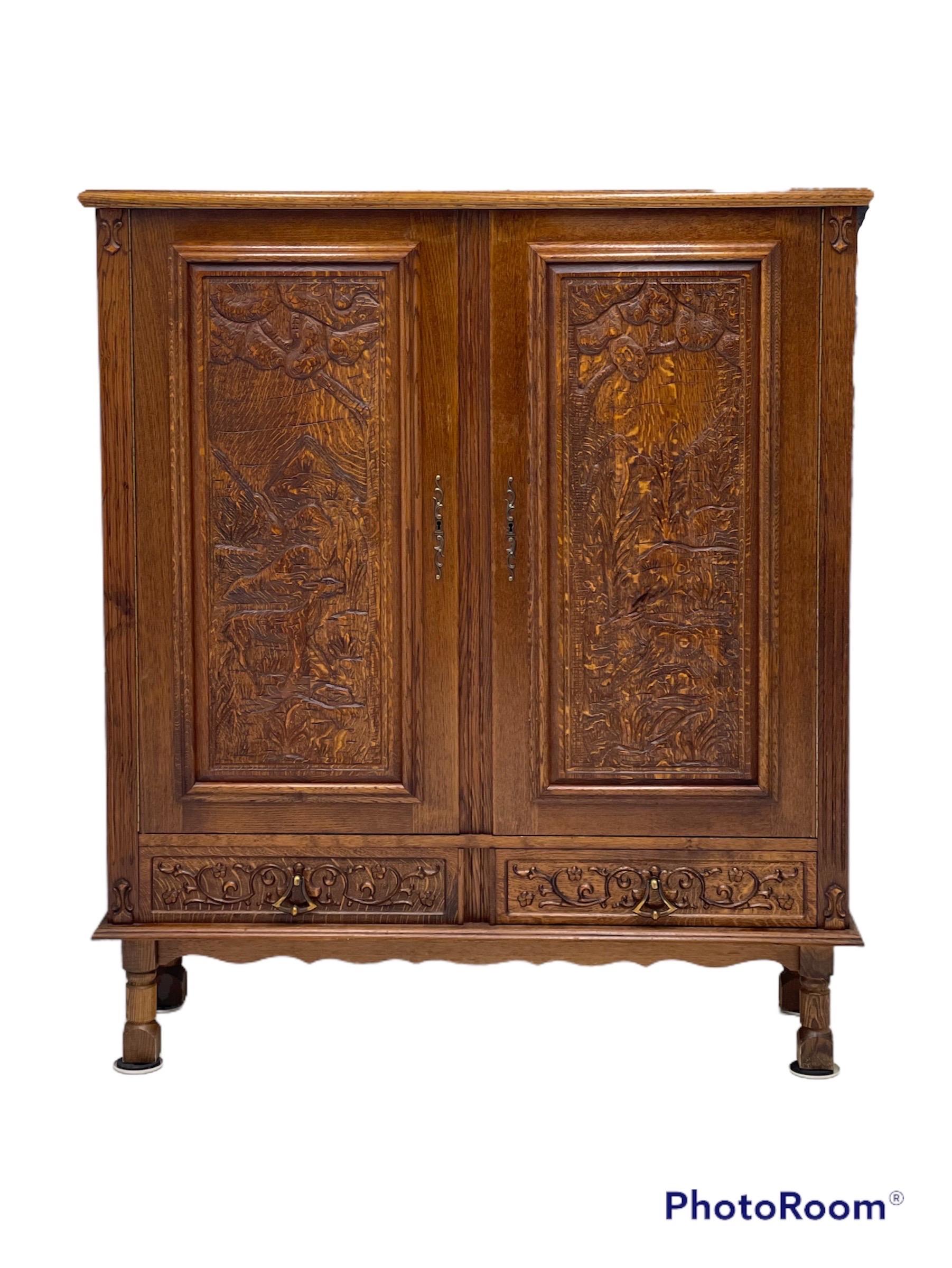 Vintage cabinet from Germany with hand carved motifs, circa 1930s

Dimensions. 53 W ; 16 D ; 60 1/2 H.