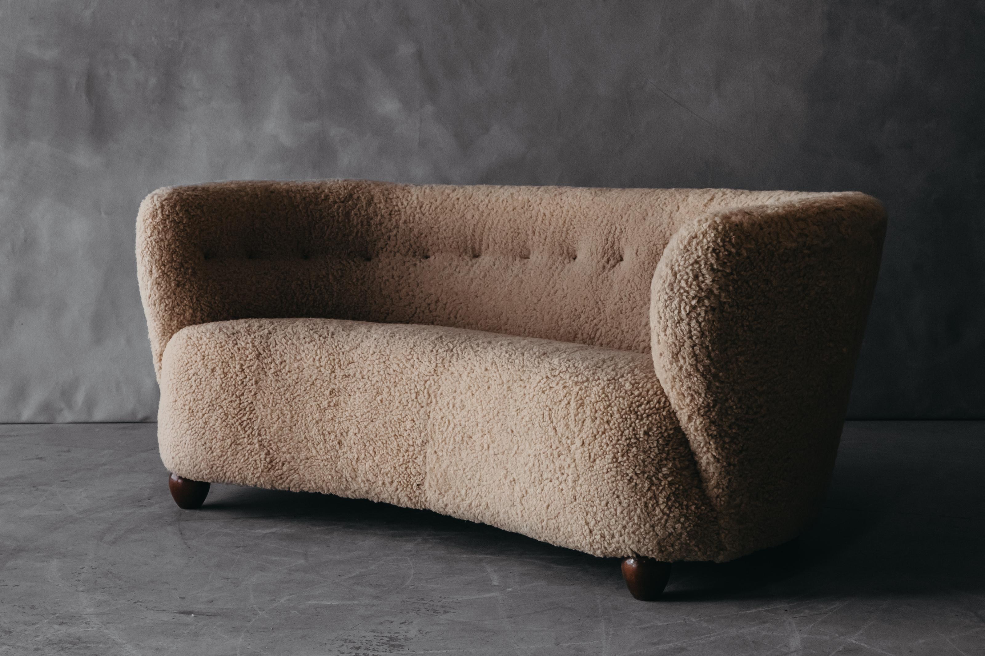 Vintage cabinetmaker sheepskin sofa from Denmark, Circa 1950. Very comfortable model, later upholstered in premium shearling.

We don't have the time to write an extensive description on each of our pieces. We prefer to speak directly with our