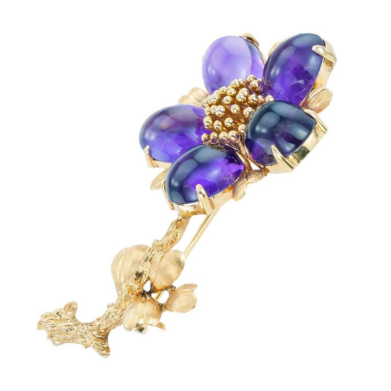 Vintage cabochon amethyst and yellow gold flower brooch circa 1960.  Love it because it caught your eye and we are here to connect you with beautiful and affordable jewelry.  Make yourself happy!  Simple and concise information you want to know is