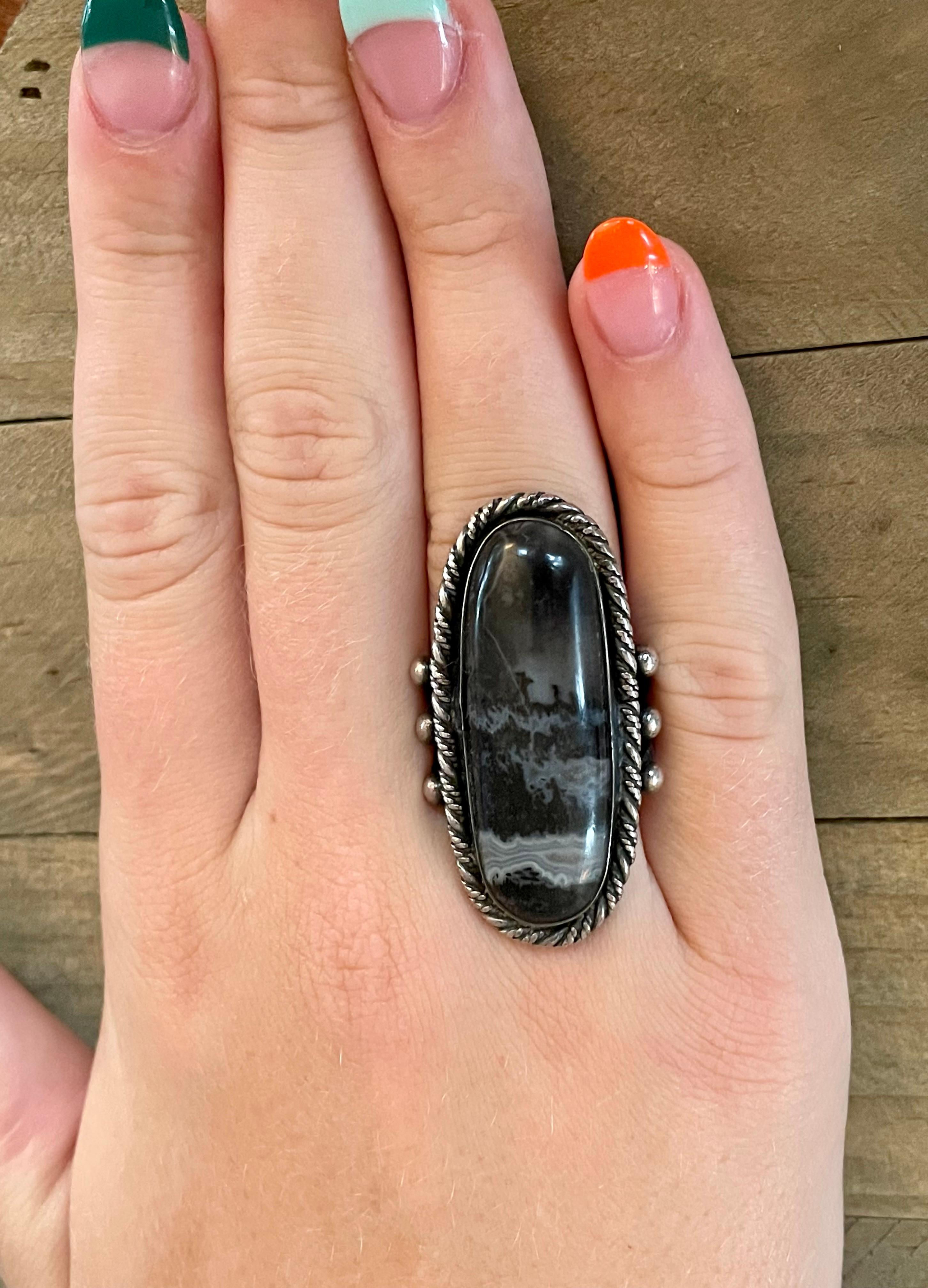 This ring is so unique; Moss Agate is lovely and the naturally occurring design is random and eye catching.

The stone measures 38 x 15mm.

Size: 6

This ring can be resized, but G. Lindberg Jewels does not provide sizing services. We recommend