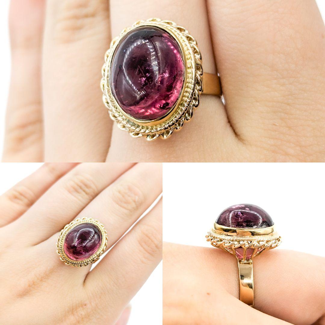 Wir präsentieren diesen wunderschönen Edelsteinring aus 14-karätigem Gelbgold. Der Ring ist mit einem atemberaubenden Rubellit-Turmalin-Cabochon von 12,87 Karat besetzt und hat ein Vintage-Design. Dieser Ring hat derzeit die Größe 7 und kann auf