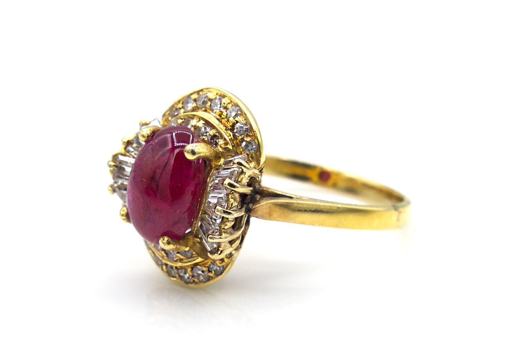 This Cabochon Ruby ring is set in 18K yellow gold with the center stone surrounded by 12 baguette diamonds and 22 round cut diamonds. 

4.5 g

Size 6.25