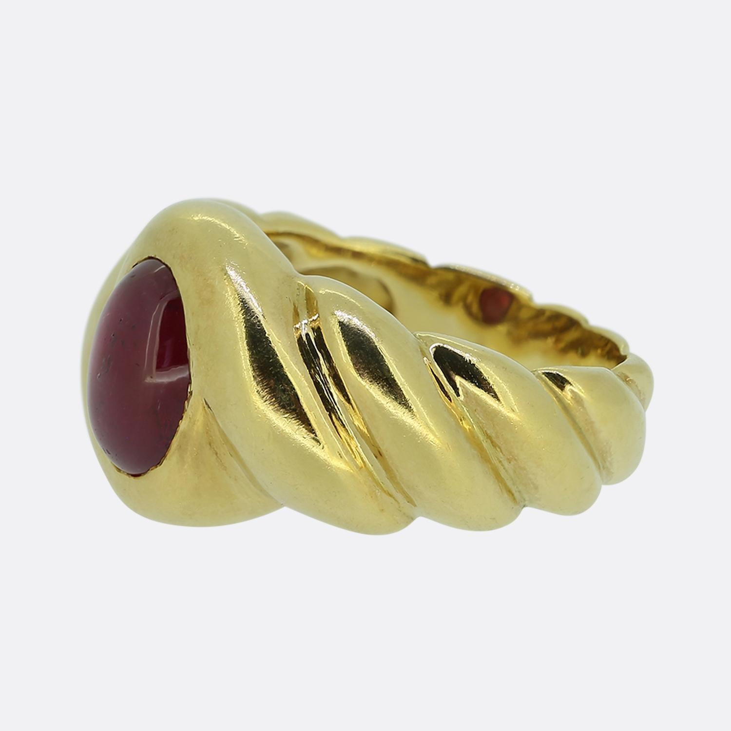 Here we have a striking single stone ring featuring a captivating cabochon-cut ruby, set in luxurious 18ct yellow gold. The deep red hue of the ruby is beautifully complemented by the warm tones of the gold, creating a harmonious and elegant design.