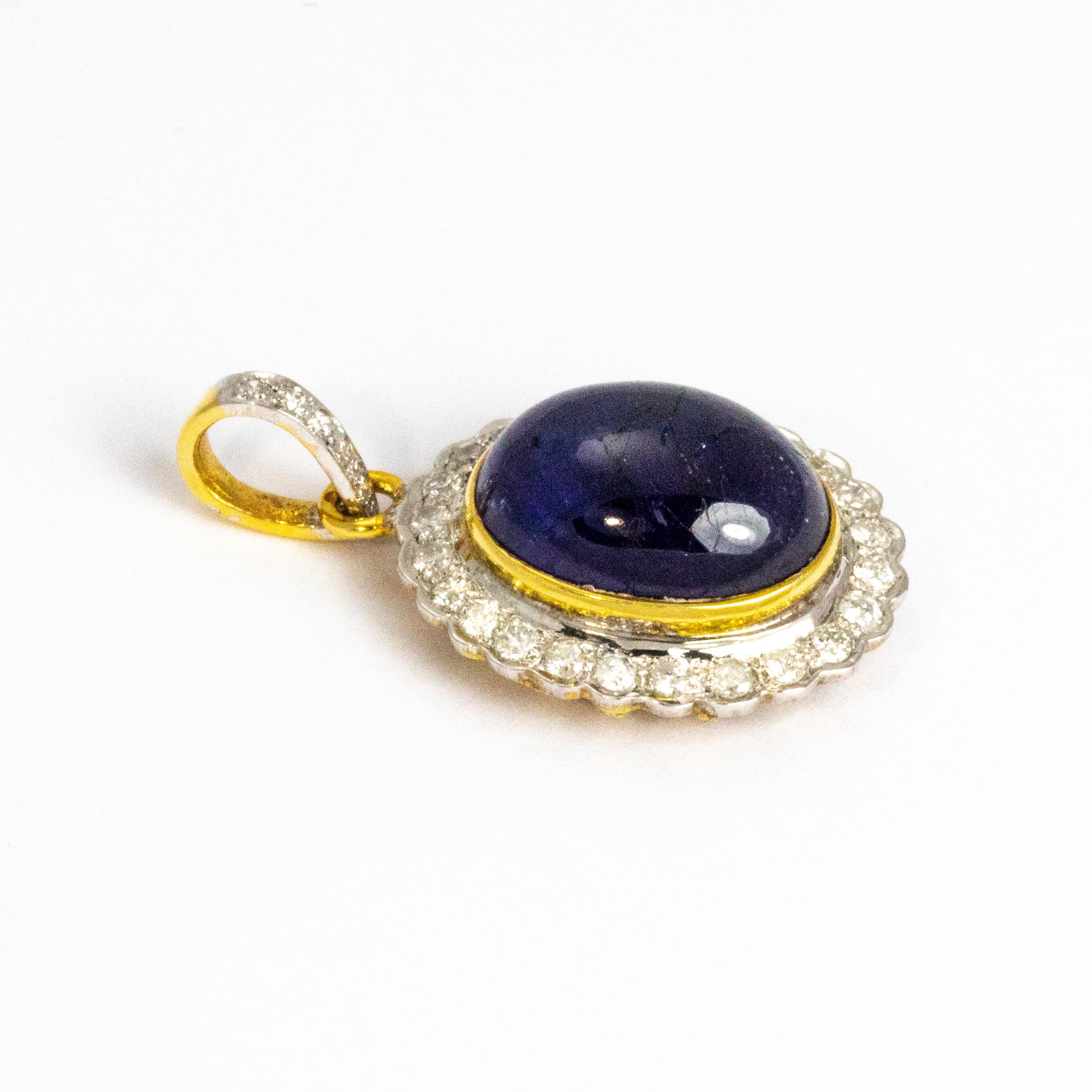 Sparkling diamonds surround a glossy deep blue Cabochon and is all set in 18ct gold. The back of this pendant is almost as beautiful as the front and even the loop at the top of the pendant holds tiny glittering diamonds, a piece bursting with