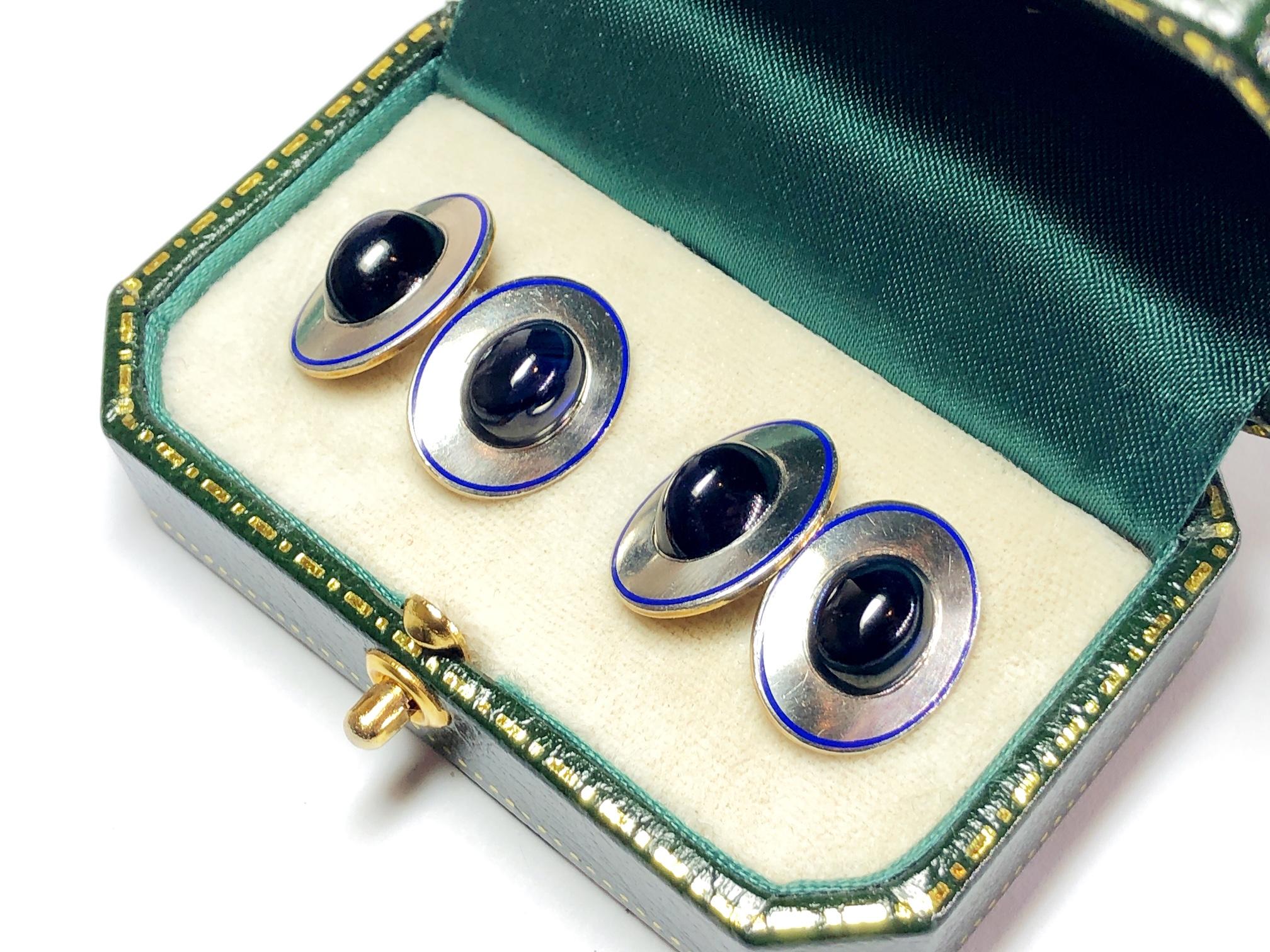 A pair of vintage oval cufflinks, set with a central oval cabochon-cut sapphire, with a blue enamel border, mounted in platinum on 14ct gold, stamped plat.&gold, with chain link fittings, circa 1970.