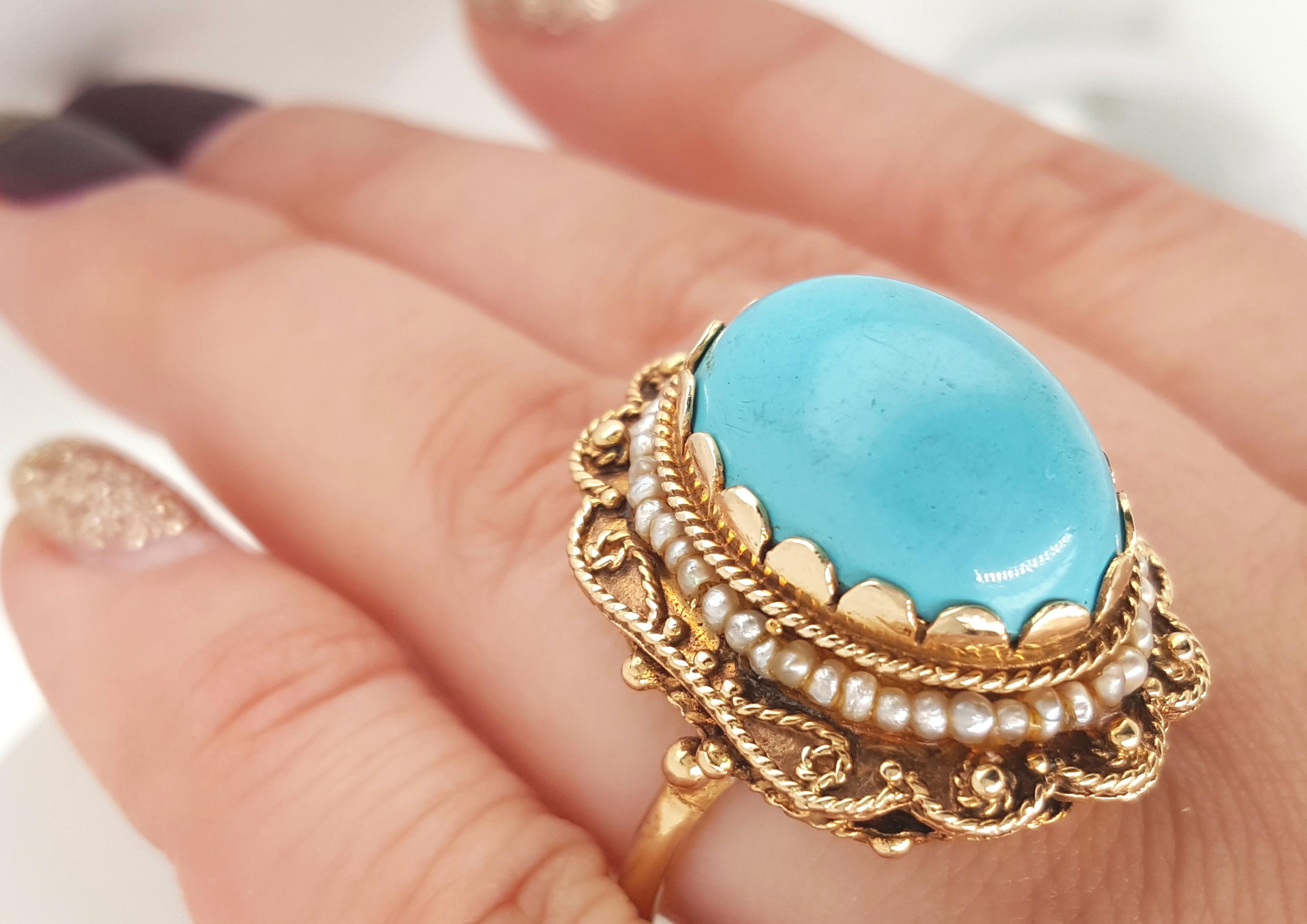 Vintage 14 Karat yellow gold ring includes a beautiful bright blue Turquoise cushion-cabochon center. The turquoise center is bezel set in a yellow gold frame that has a leafy etching pattern with a small opening on the the gallery edges