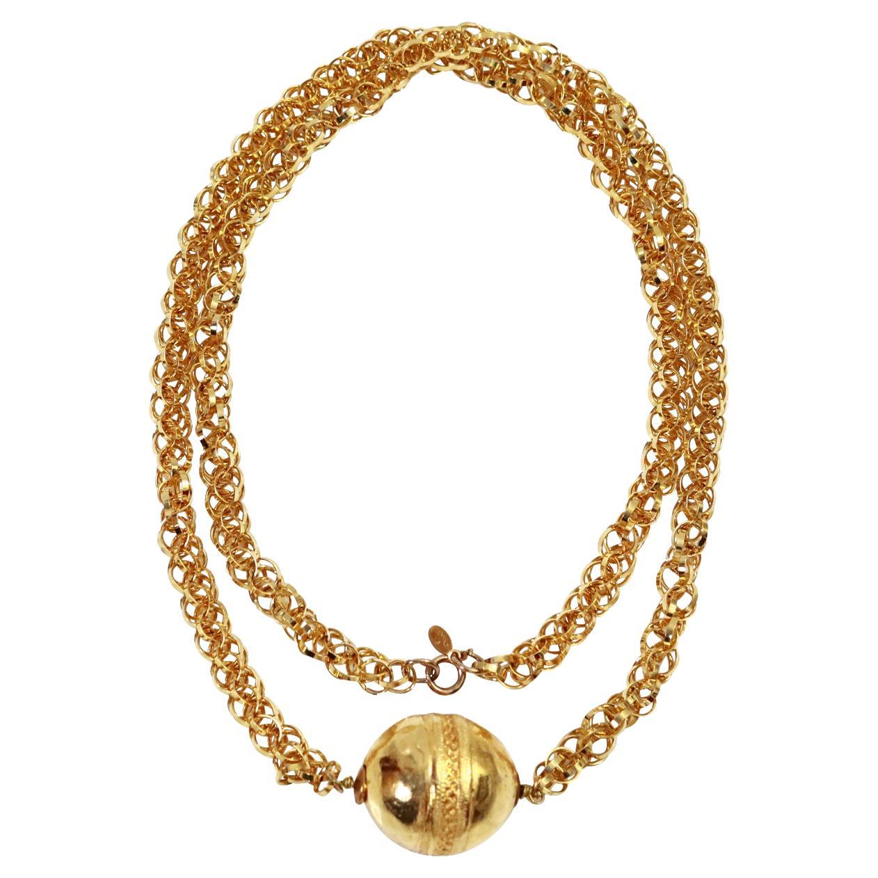 Vintage Cadoro Gold Tone Long Necklace with Ball Circa 1980s.  Very chic. This is an unusual necklace and so well made.  It can be worn long or doubled.  The oblong ball has a hammered look to it and the middle of the piece has a very intricate