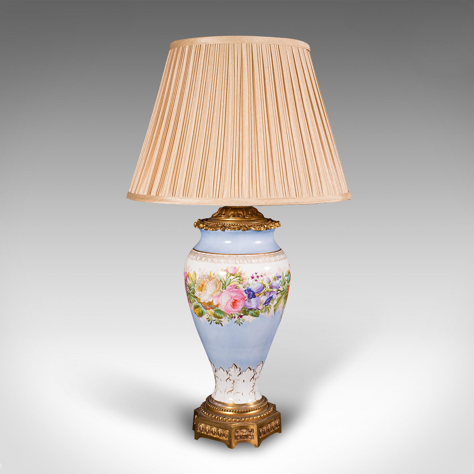 
This is a vintage cafe lamp. A French, ceramic and gilt cast metal decorative table light, dating to the early 20th century, circa 1930.

Fine table lamp with a colourful foliate appearance
Displays a desirable aged patina and in good order
Quality