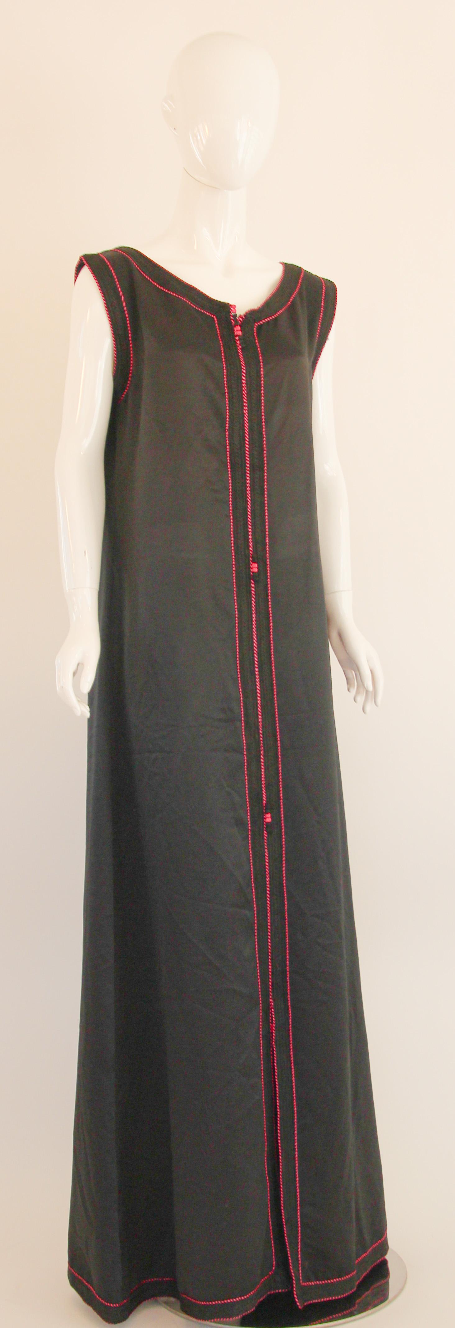 Amazing vintage handmade sleeveless caftan, black color with pink rim threads. 
Circa 1980's.
The kaftan is embroidered and embellished entirely by hand.
 This authentic caftan has been hand-sewn with a trim embroidered with hot pink and black