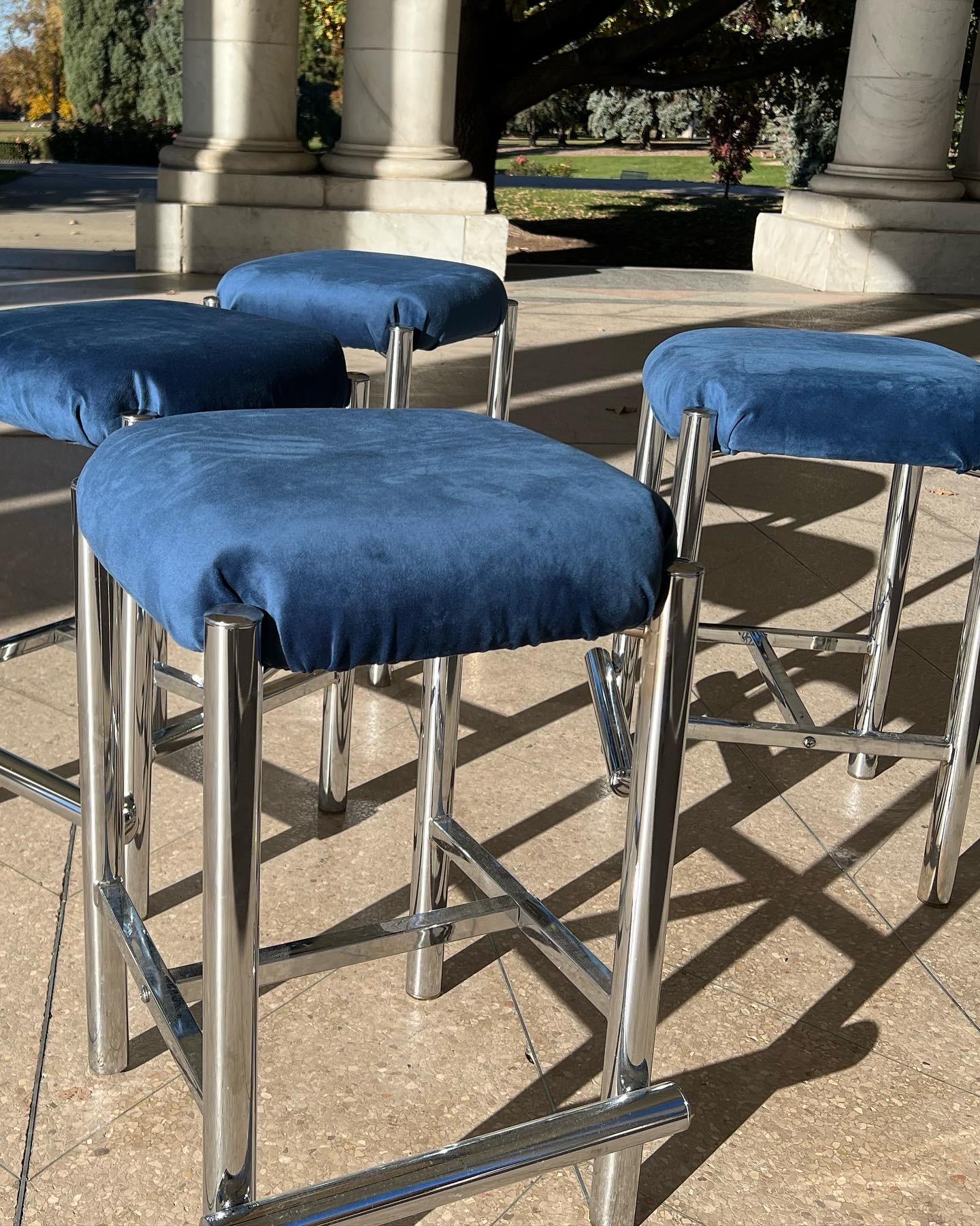 Stylish set of four bar stools with thick tubular chrome legs and beautifully-sculpted upholstered seats. The bold blue upholstery isn't original but looks fabulous. Undersides with Cal-Style manufacture.