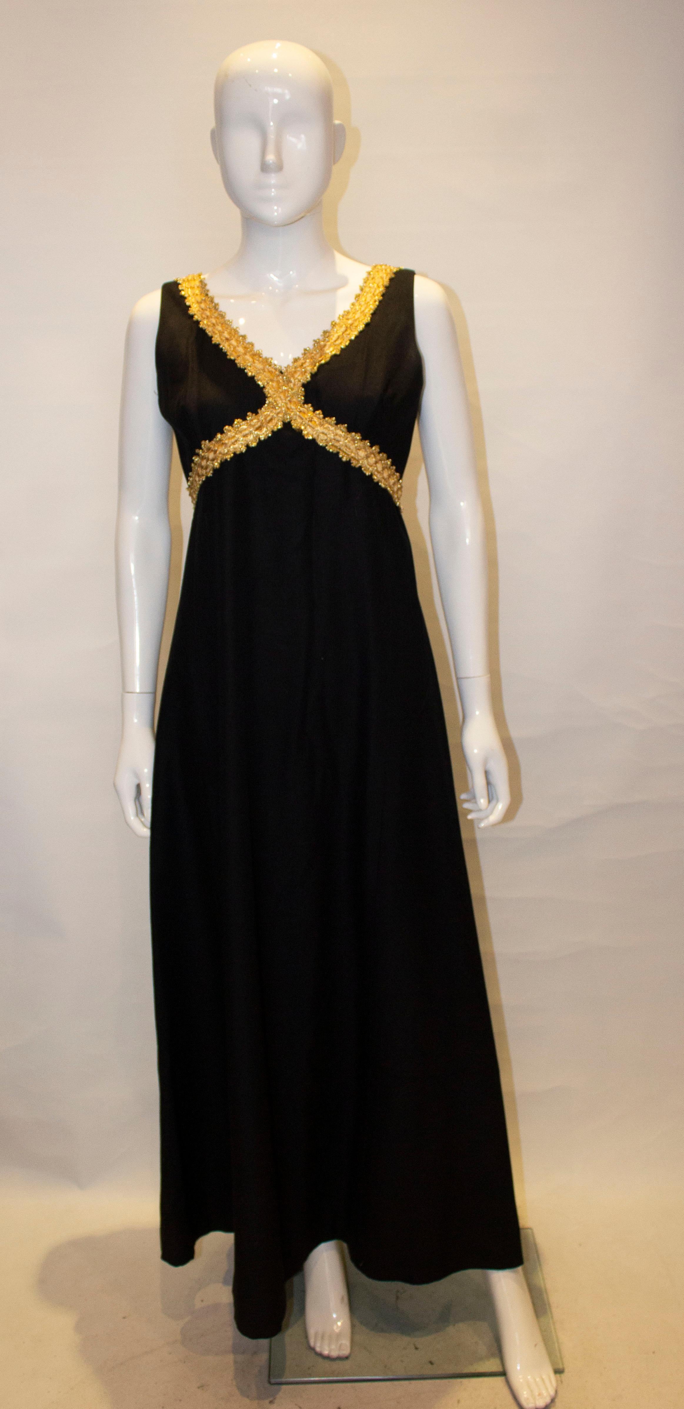 A great evening gown by California. In black with gold braid detail, the dress has a v neckline , square backline and train detail at the back. It is fully lined with a central back zip. 