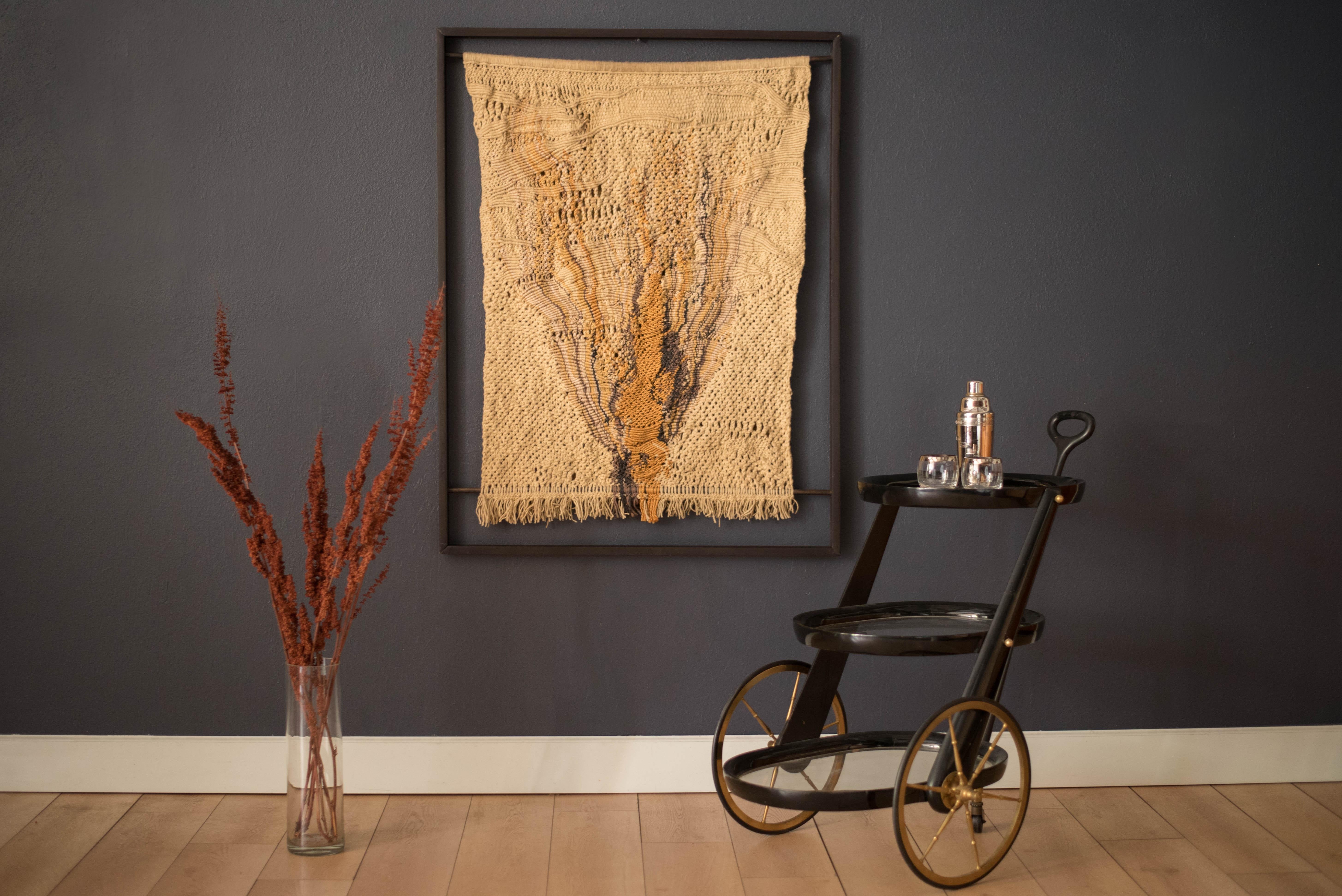 Vintage large scale original abstract fiber art tapestry made by California artist Marion Ferri, circa 1970s. Features an intricate pattern of hand knotted designs accented in a neutral palette of gold, grey, and black tones. Captured in a floating