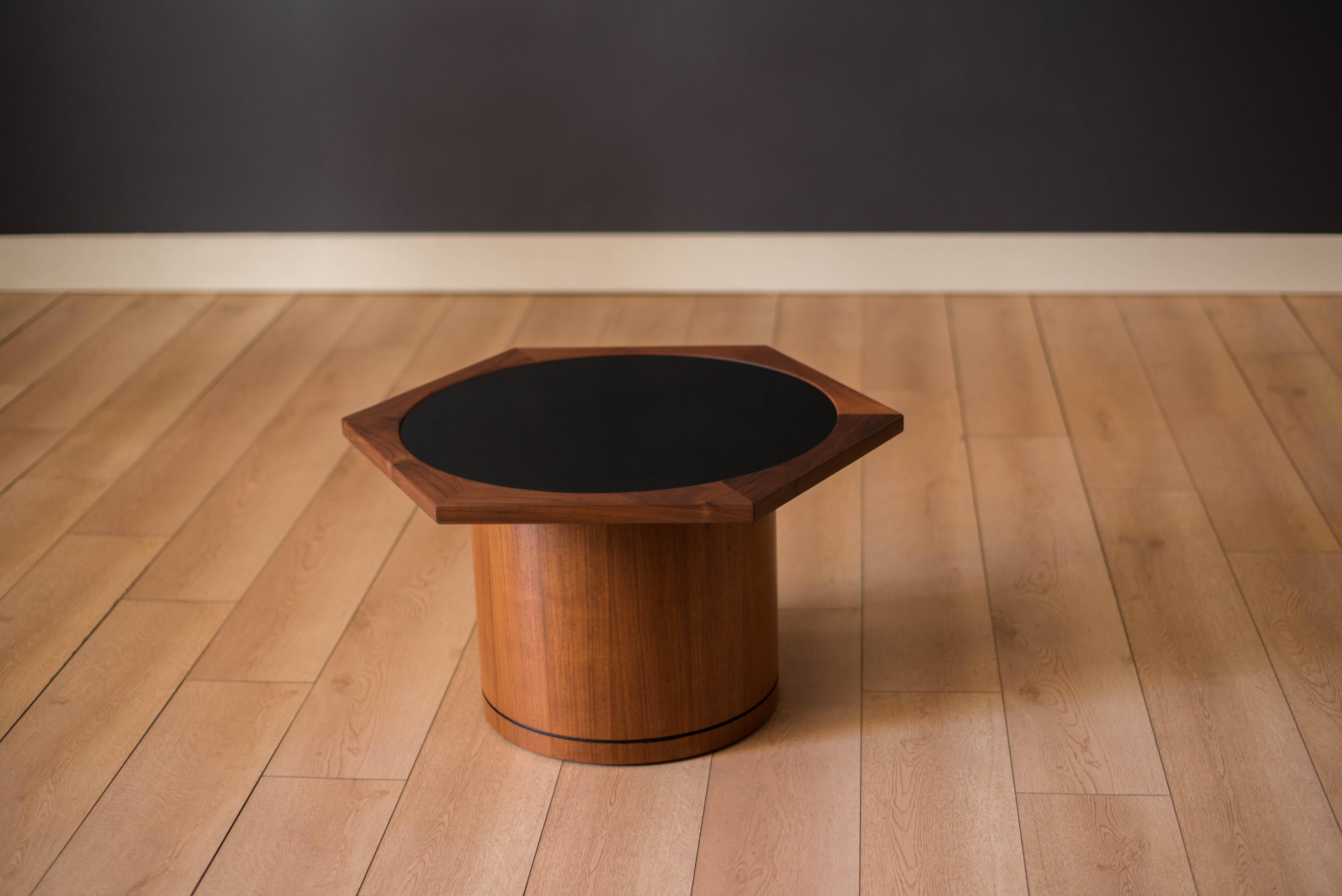Mid-Century Modern occasional accent end table manufactured by Brown Saltman c. 1960's. This piece features a unique walnut hexagon design with a round black laminate top. Easy to maintain surface is ideal for resting drinks on.




Offered by Mid