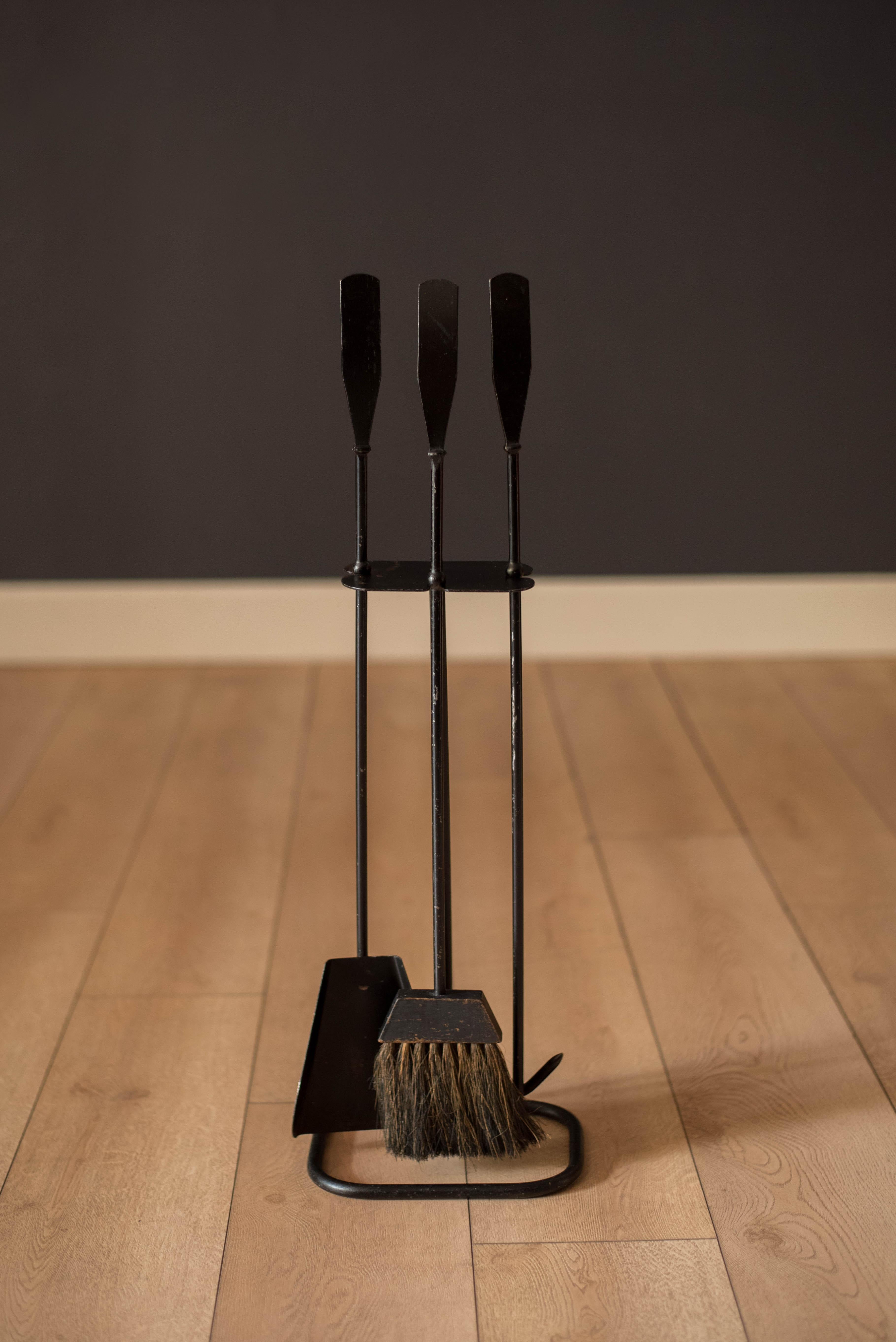 Mid-Century Modern three piece fireplace tool set designed by Luther Conover of Sausalito, California circa 1950's. This set features a heavy cast iron ring stand and includes a poker, shovel, and brush.

 