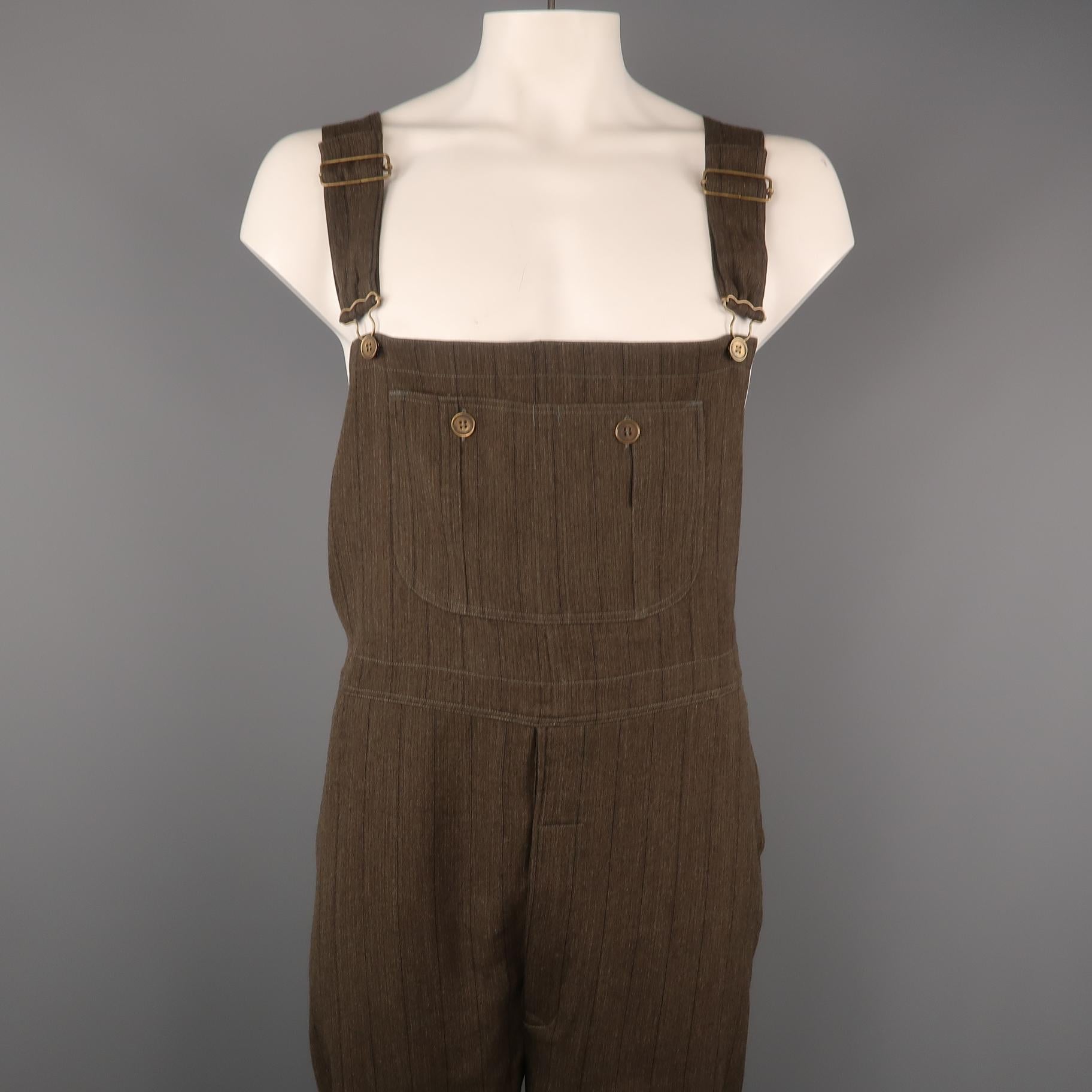 Vintage CALVIN KLEIN COLLECTION relaxed fit overalls come in olive striped cotton with a pouch pocket, adjustable straps, and antique gold tone button hardware. Made in Italy.
 
Excellent Pre-Owned Condition.
Marked: L
 
Measurements:
 
Waist: 44