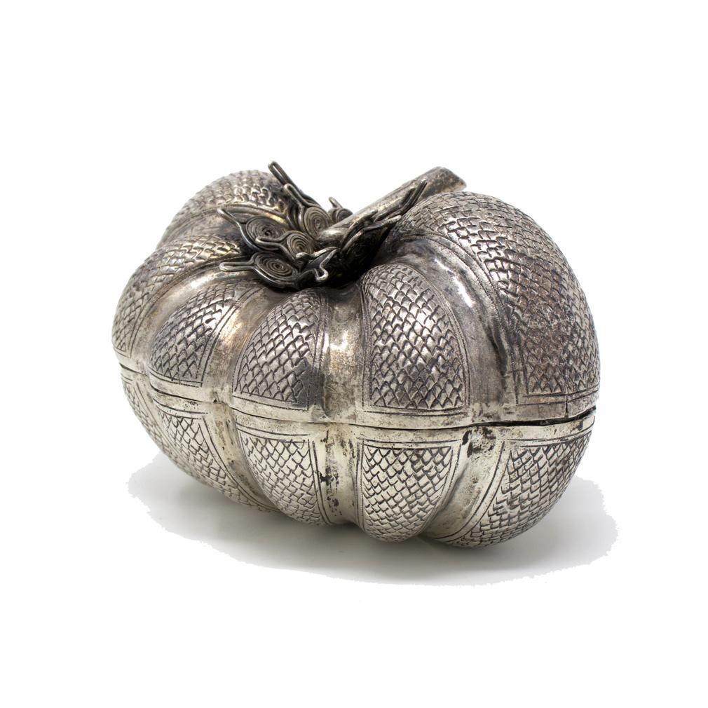 Vintage Cambodian Repoussé Silver Pumpkin Shaped Box. A squat low form with sections having chased and punched scales, coiled silver wire sepals in two layers and a solid twisted stem. The box separates into two tight fitting halves. Scratched “#”
