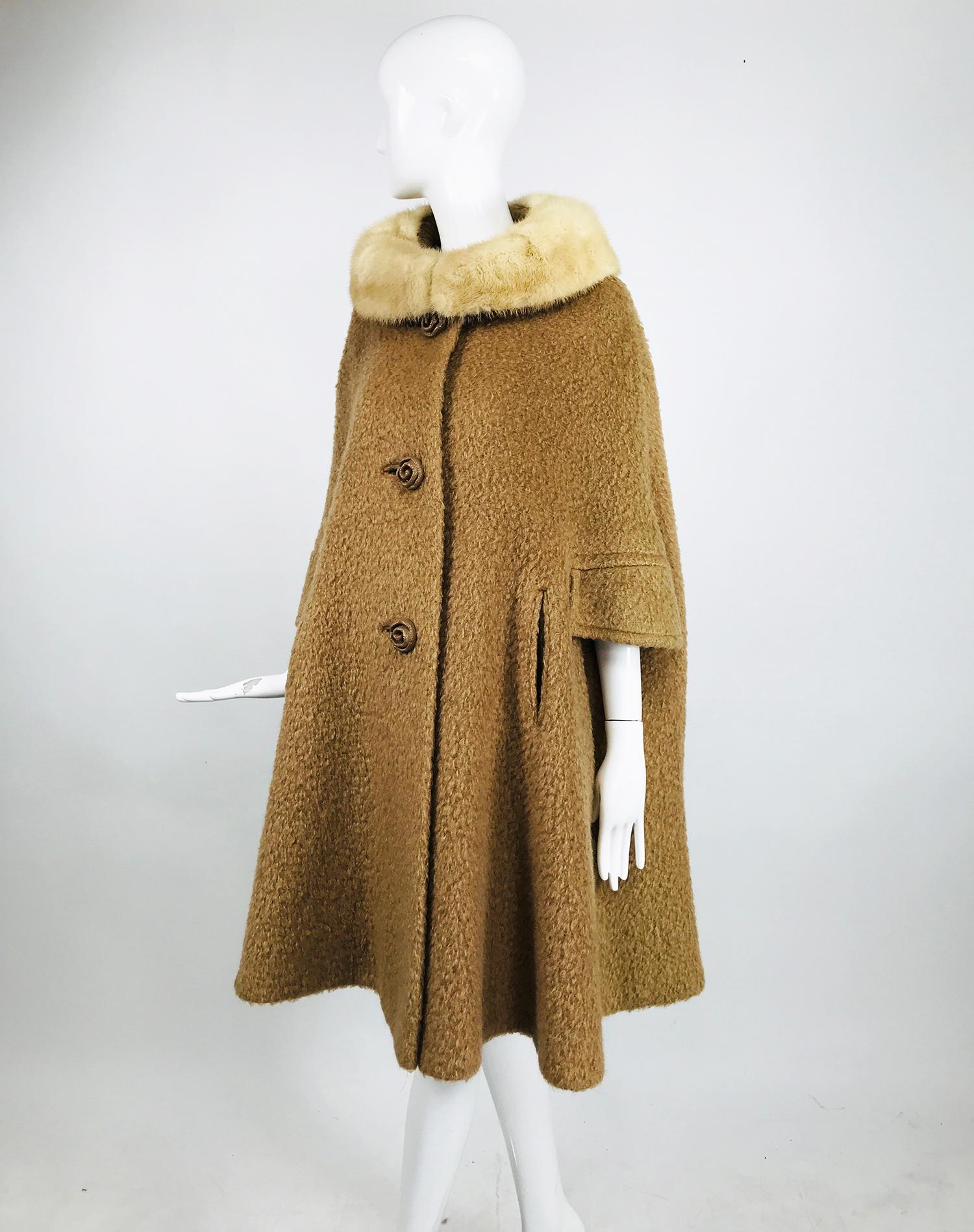 Vintage mohair cape coat with mink collar from the 1960s. Camel colour mohair wool cape has a shaped shoulder and A line shape. The cape closes at the front with 3 large rose shape buttons. There are flaps at each front side with openings below the