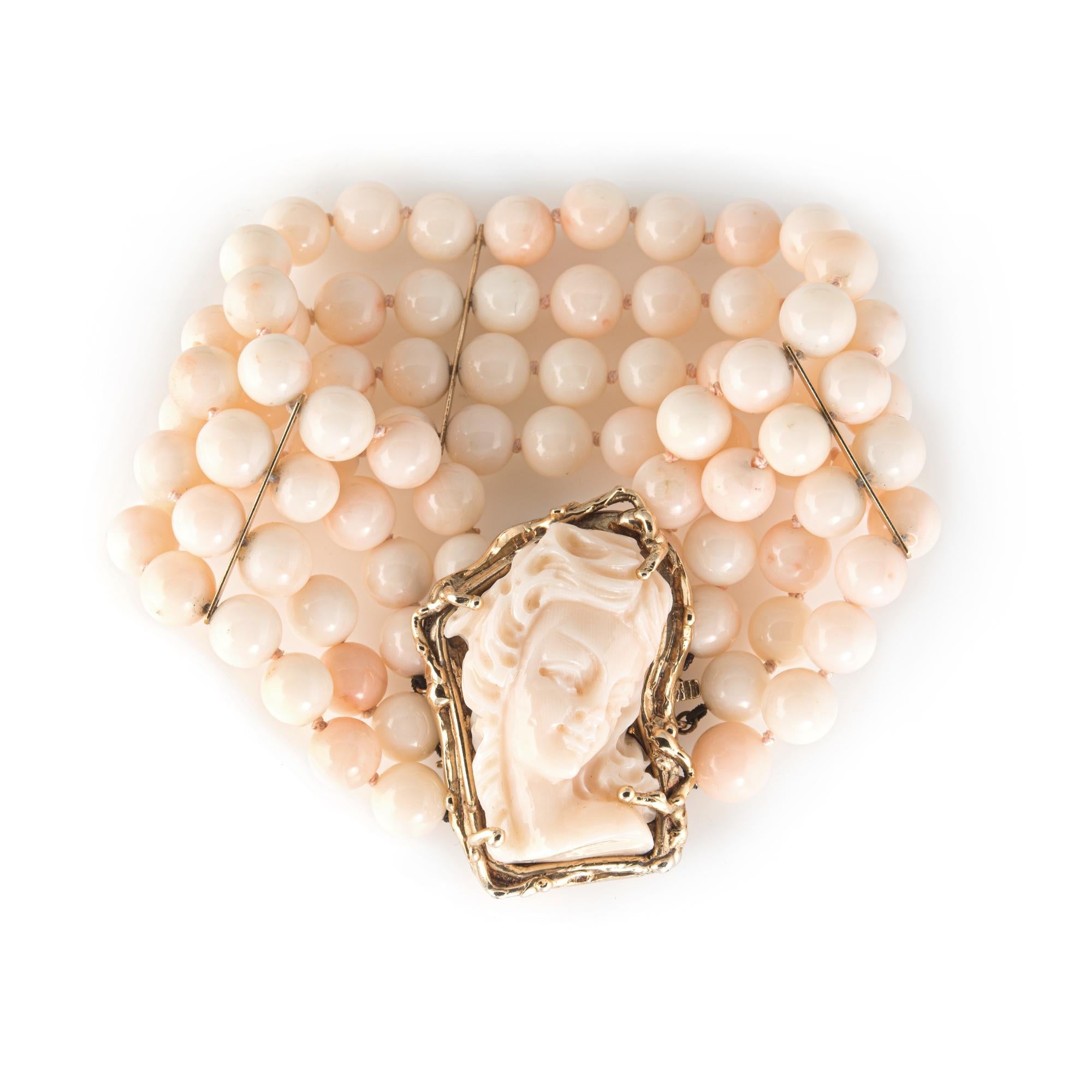 Finely detailed vintage angel skin coral bracelet (circa 1950s to 1960s), crafted in 14 karat yellow gold. 

The bracelet features a large piece of coral measuring 35mm x 22mm set into the clasp and carved with the profile of a woman. The bracelet