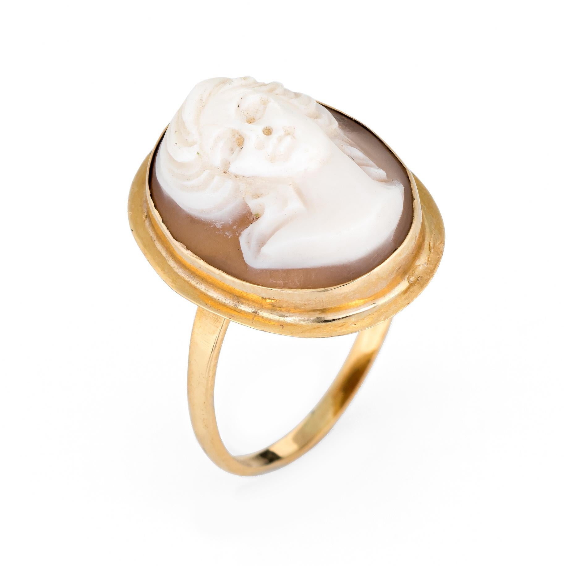 Elegant vintage cameo ring crafted in 18 karat yellow gold. 

Shell cameo is carved in the bust of a woman measuring 15mm x 10mm. The cameo is in excellent condition and free of cracks or chips. 

The cameo features a graceful bust of a woman in