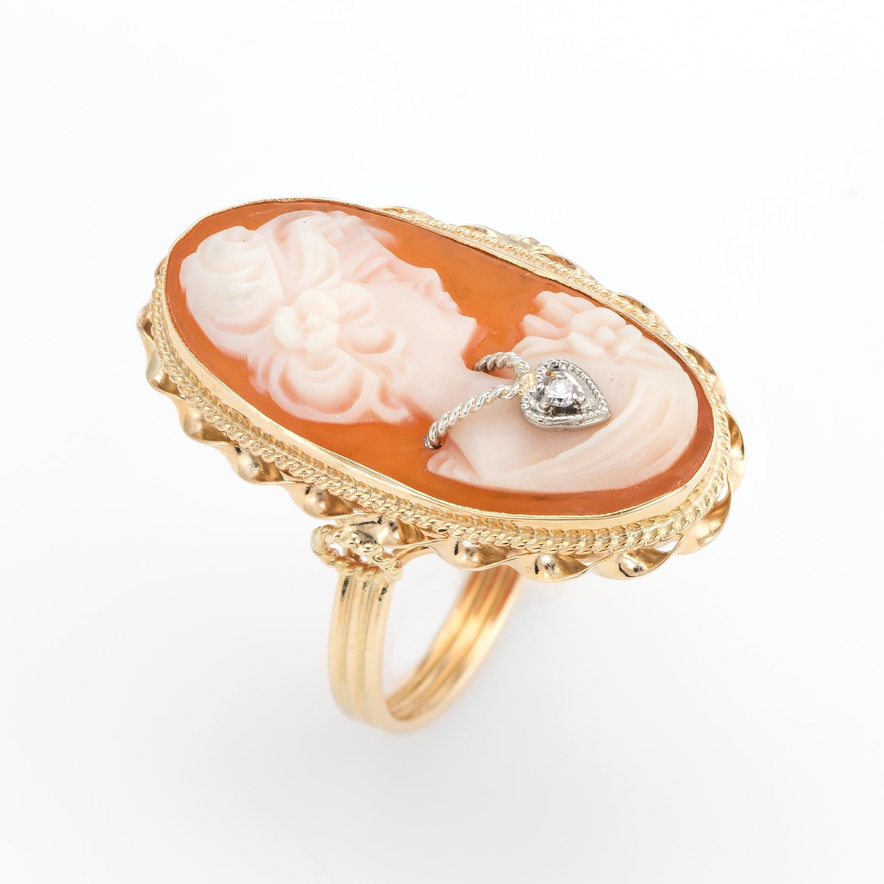 Finely detailed vintage cameo cocktail ring, crafted in 14 karat yellow gold. 

Carved shell cameo features a portrait of a woman, measuring 23mm x 11mm. The cameo is in excellent condition and free of cracks or chips. The single cut diamond is