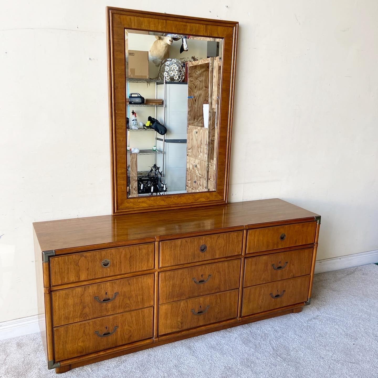 Incredible vintage Accolade campaign dresser with mirror by Drexel Heritage. Features 9 spacious drawers with inlaid brass drawer pulls. Dresser is on wheels.

Mirror measures 33.75” W, 1.25” D, 47.75” H.