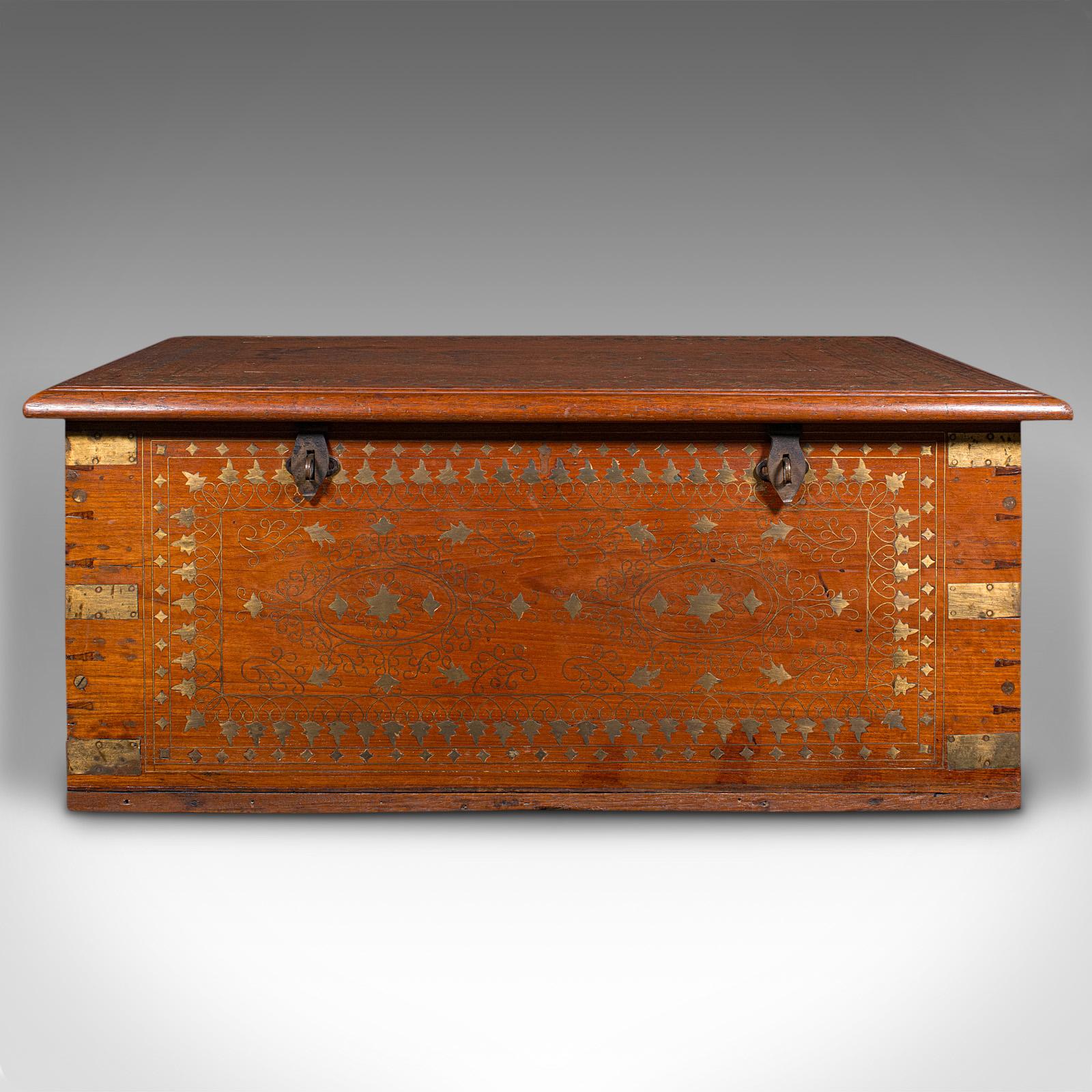 This is a vintage campaign chest. An Anglo-Indian, teak and brass inlaid decorative trunk, dating to the Art Deco period, circa 1940.

Appealing decorative finish and of useful proportion
Displays a desirable aged patina and in good order
Teak