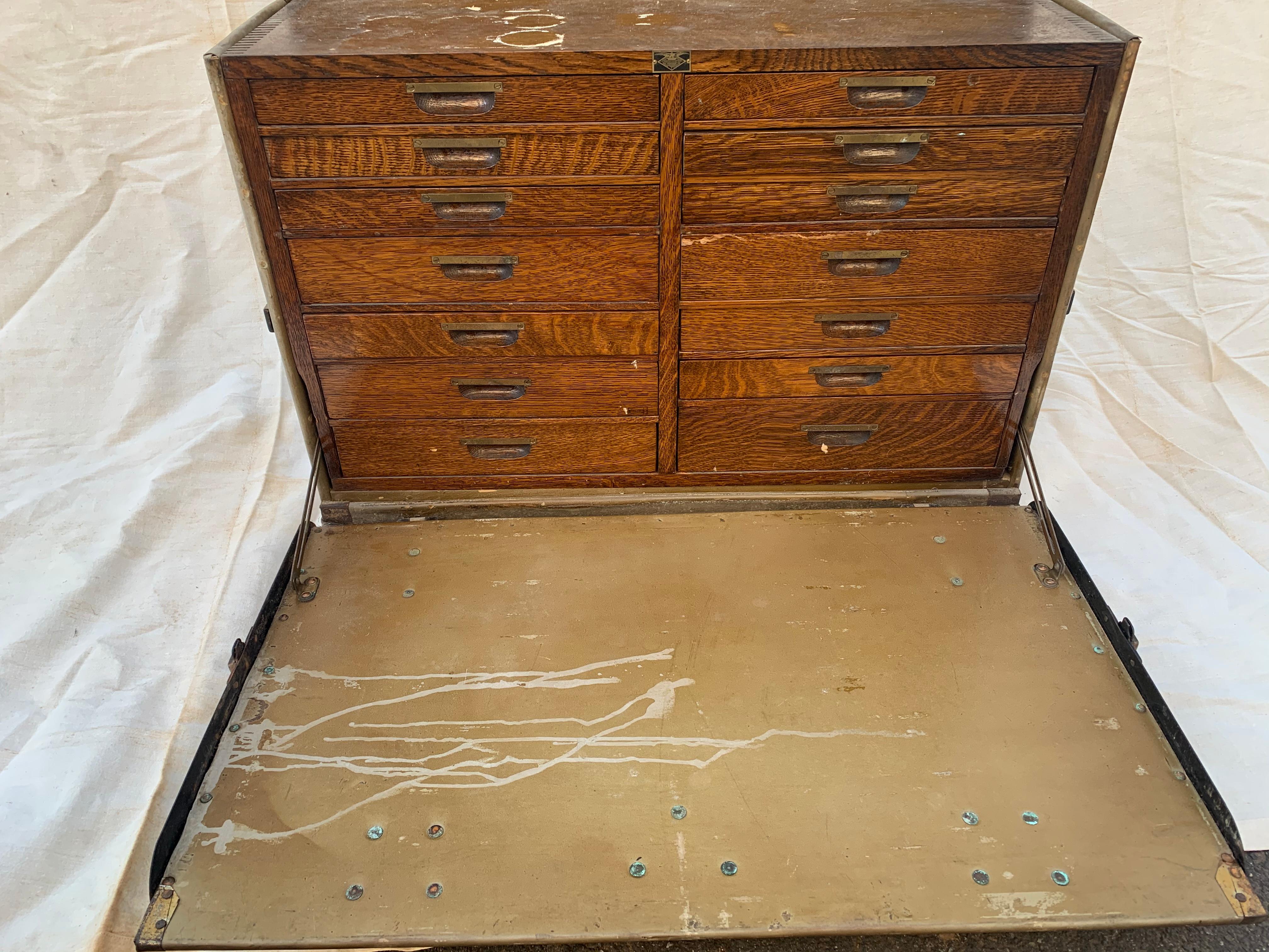 A rare Campaign style WWII US Army Medical field desk trunk made by the American Cabinet Company that says Dental Instrument desk operating on the top. It has a fabulous industrial masculine look when closed with original chunky hardware and