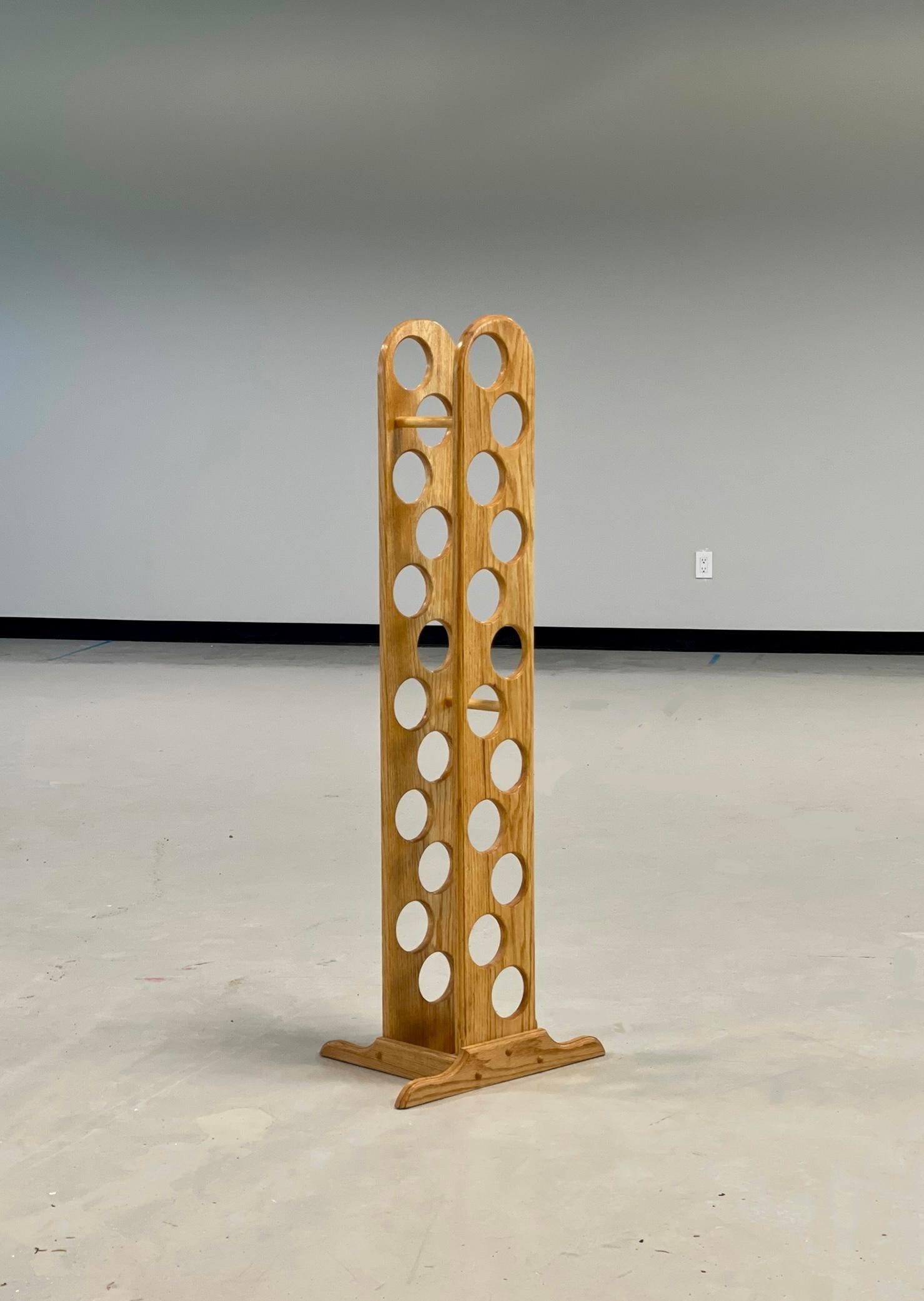 Vintage Canadiana solid oak rustic vertical wine rack. A fun, intersecting piece between farmhouse modern and playful design. 
Sturdy without being clunky. Sleek and inoffensive. 

Holds 12 bottles of wine. Display your favourites, or start a new