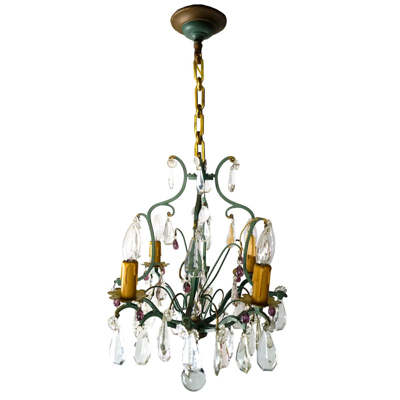 A vintage crystal chandelier with four drip candles. Wired and ready!