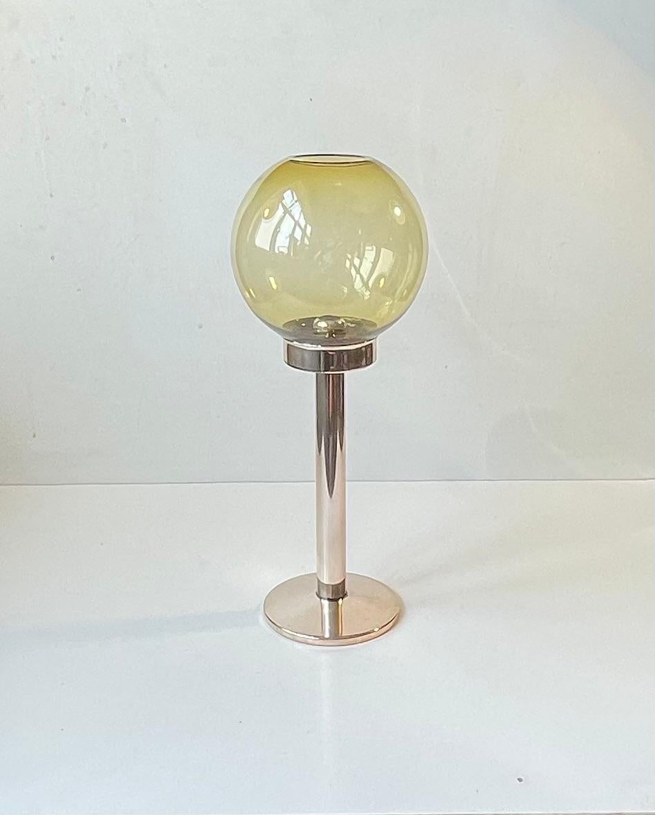 A rare candlestick lamp for regular sized candles. It''s special features is that the hidden candle is spring-loaded within the tube. As it burns the spring pushes the candle upwards. Its very similar to Hans Agne Jakobsson's Restaurant lamp. It was
