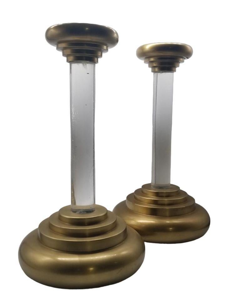 The vintage candlestick holder by Charles Hollis Jones seamlessly combines timeless elegance with modern sophistication. Crafted with meticulous attention to detail, this exquisite piece features a fusion of brass and lucite, creating a stunning