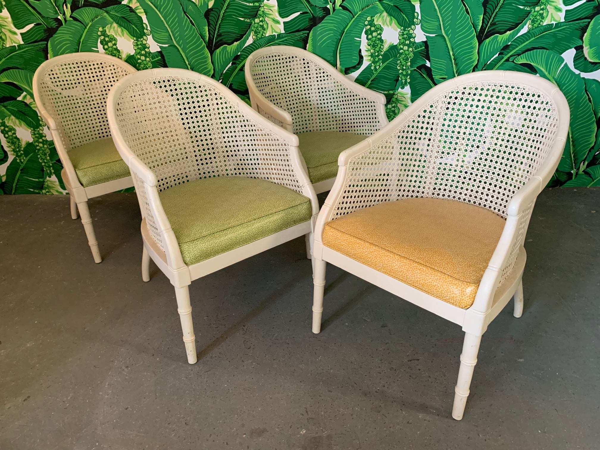 Set of 4 barrel chairs feature cane backs and vinyl upholstery in a fun vintage print. One chair in yellow vinyl and three in green. Very good vintage condition with minor imperfections consistent with age.