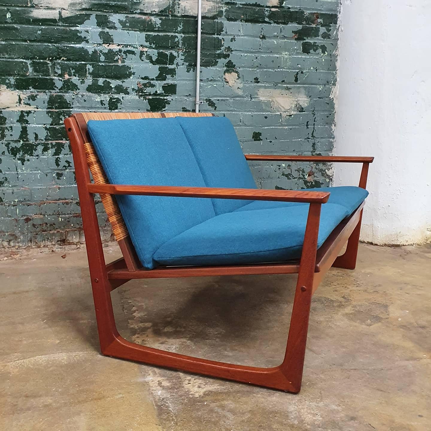 Beautiful danish teak settee by Hans Olsen. New teal wool upholstery. the seat cords have been replaced. newly woven cane seat back done by a professional caner. This chair is a comfortable statement piece and would look great in a variety of