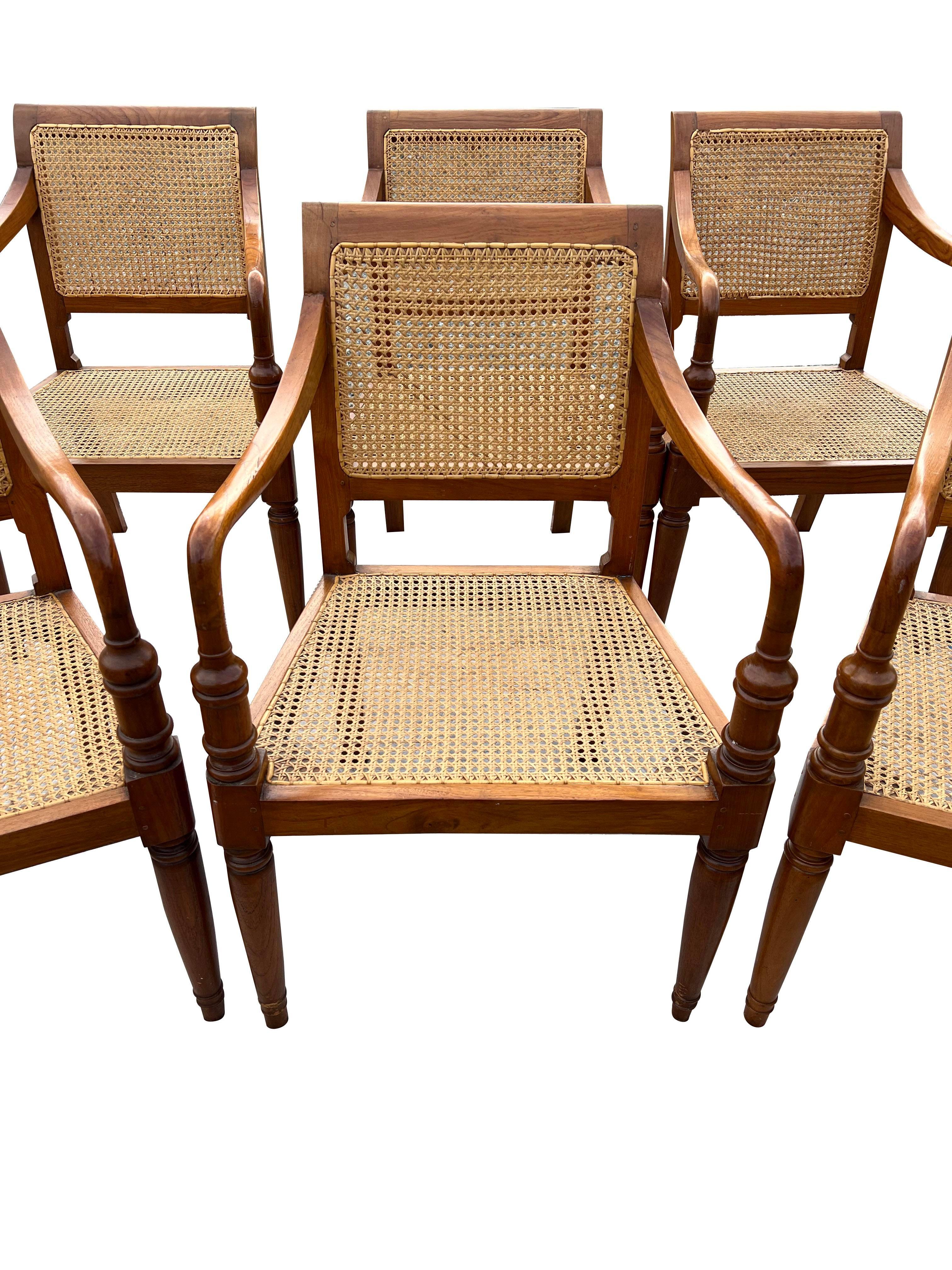 Vintage Cane Wood Dining Arm Chairs.

This set of six vintage cane wood dining arm chairs offers a timeless appeal and comfortable seating. The intricate cane detailing and sturdy wood frame make these chairs a stylish addition to any dining