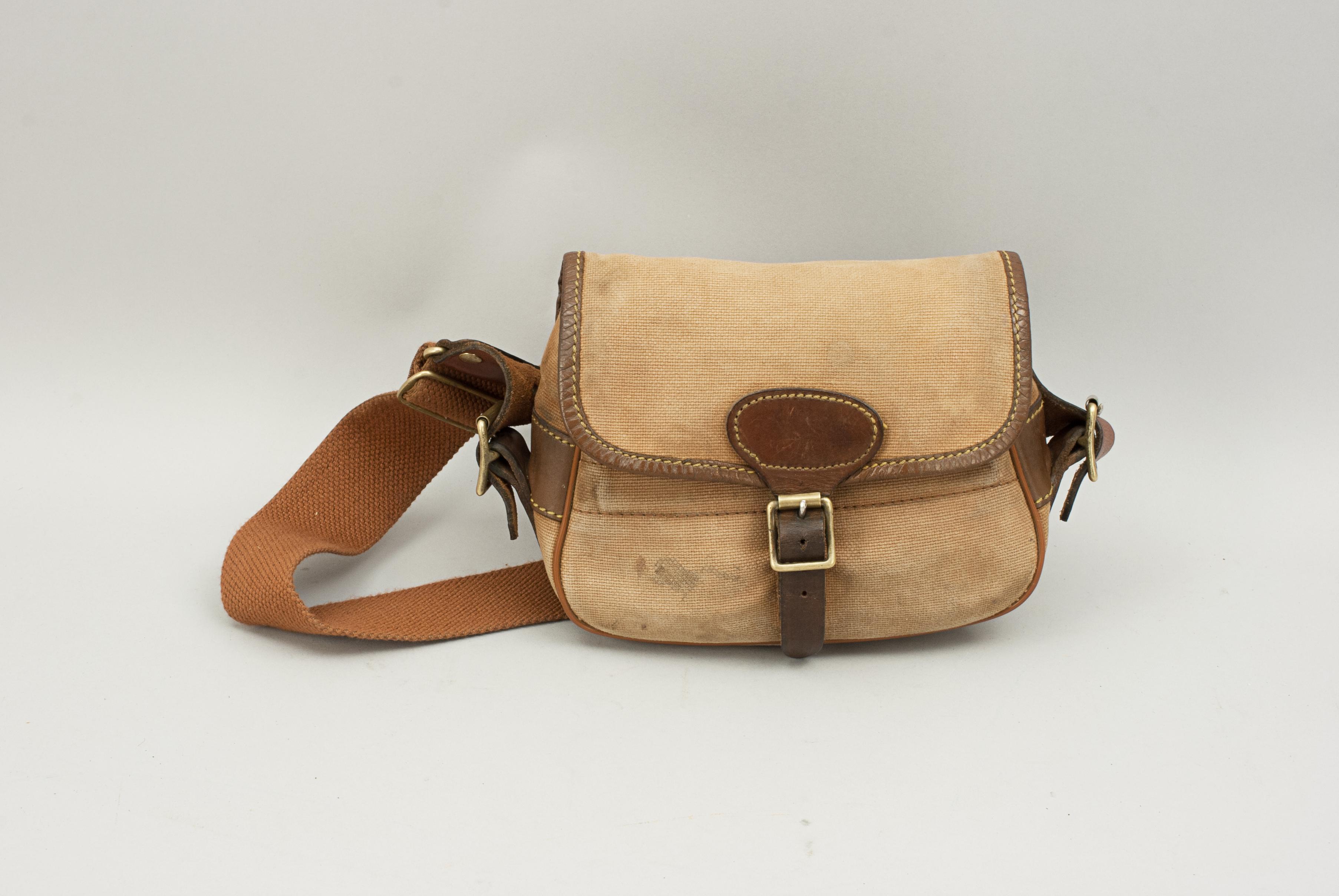 Vintage Canvas Cartridge Bag.
A good quality small canvas cartridge bag. The bag is in good usable condition with brass fittings, leather trim and a replaced cotton web adjustable shoulder strap. The case holds about 50 cartridges. A nice cartridge