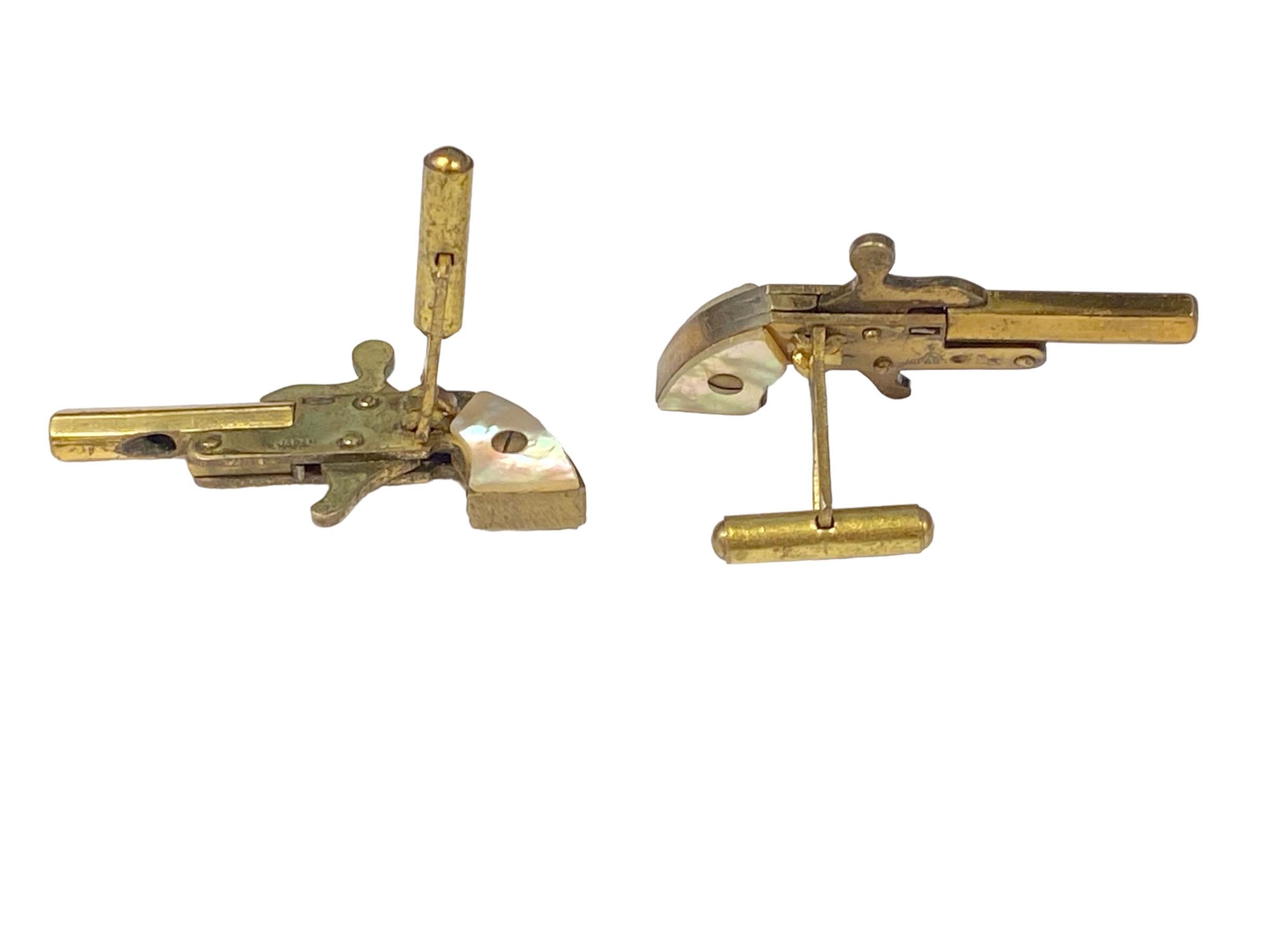 Circa 1960s Cap Pistol Cuff-links, measuring 1 3/4 inches in length, Brass with Mother of Pearl Handles, these are very detailed and are working miniature guns that shoot blank caps.  